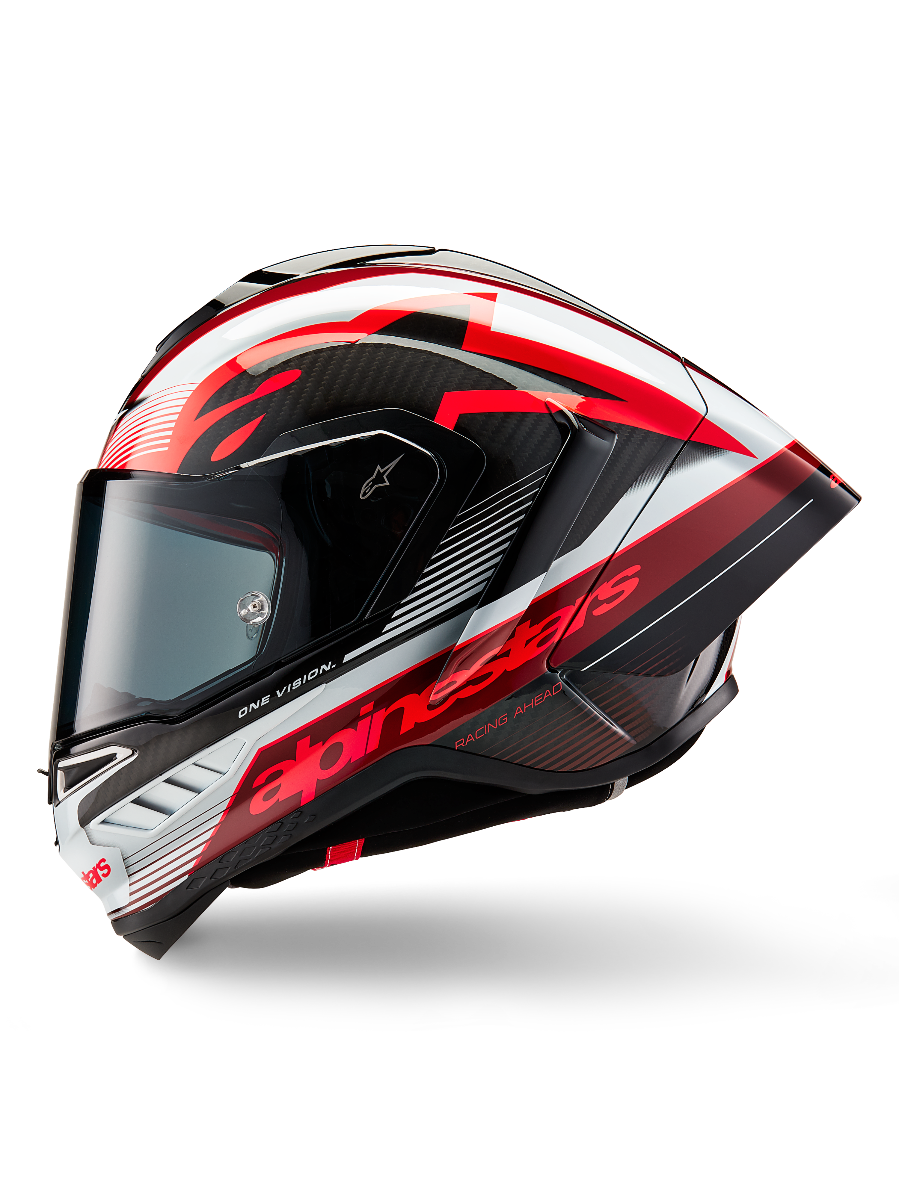 Kask Alpinestars Supertech R10 Team, pełny kask motocyklowy wyścigowy, błyszczące wykończenie w kolorach czarnego karbonu, czerwieni i bieli, profil boczny ukazujący aerodynamiczny design, wyraziste czerwone napisy „One Vision” i „Racing Ahead”, konstrukcja z włókna węglowego