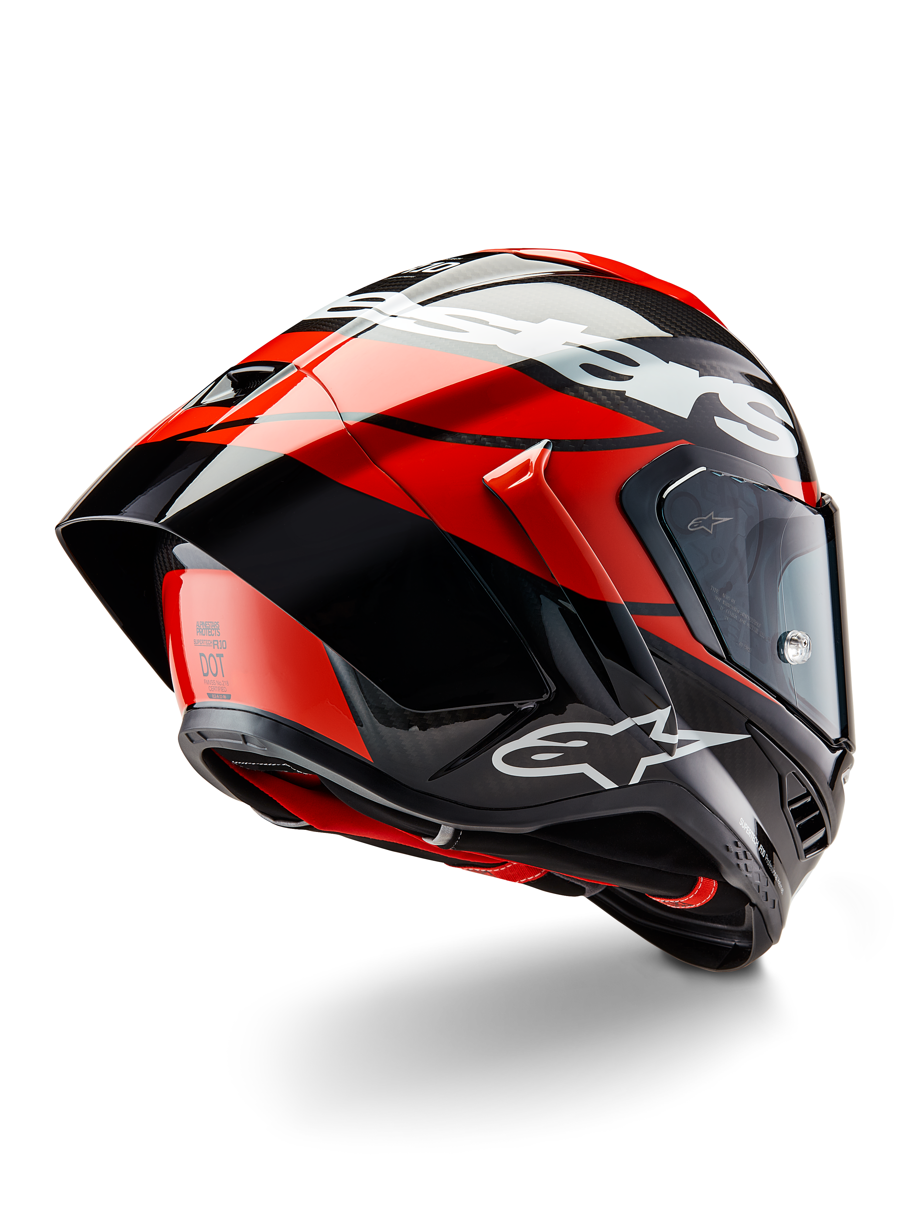 Kask Alpinestars Supertech R10 Element, czarny karbon, intensywna czerwień i biały połysk, widok z tyłu pod kątem trzech czwartych pokazujący duży spojler aerodynamiczny i skorupę z włókna węglowego, z wyraźnymi logotypami Alpinestars i certyfikatem DOT