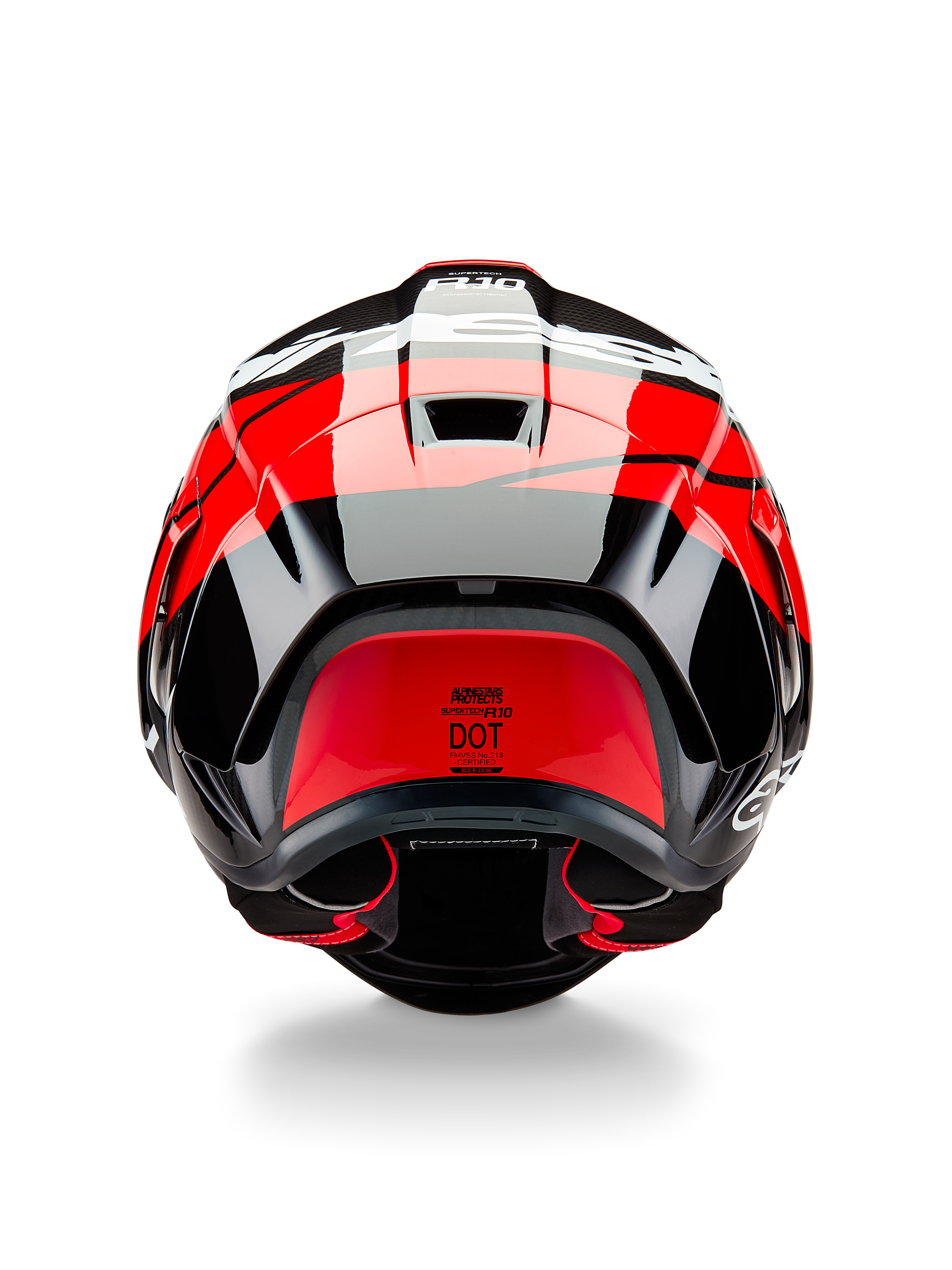 Kask Alpinestars Supertech R10 Element, widok z tyłu, czarny karbon z jaskrawoczerwonymi i białymi błyszczącymi akcentami, aerodynamiczny tylny spojler, otwory wentylacyjne i certyfikat DOT, wyścigowy design z detalami z włókna węglowego