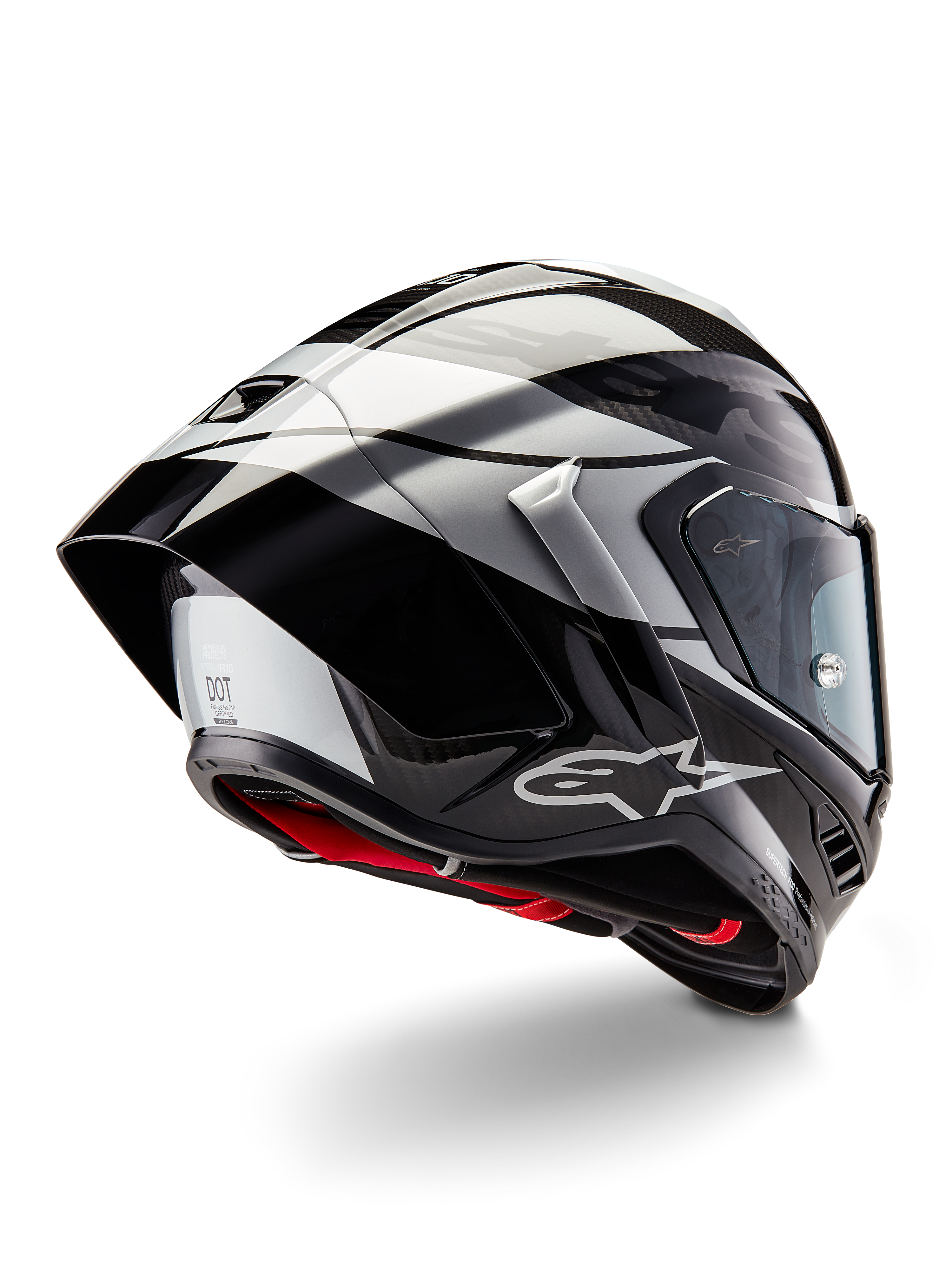 Kask Alpinestars Supertech R10 Element, czarny karbonowy srebrno-czarny z połyskiem, widok z tyłu pod kątem trzech czwartych ukazujący aerodynamiczny profil wyścigowy, błyszcząca skorupa z włókna węglowego z geometrycznymi szarymi i czarnymi grafikami, logo Alpinestars i czerwona wyściółka wewnętrzna