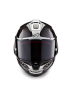 Kask Alpinestars Supertech R10 Element, integralny kask wyścigowy, czarny karbon, srebrny i czarny połysk, widok z przodu z ciemnym dymionym wizjerem, błyszczący splot włókna węglowego, srebrne grafiki aerodynamiczne i logo Alpinestars