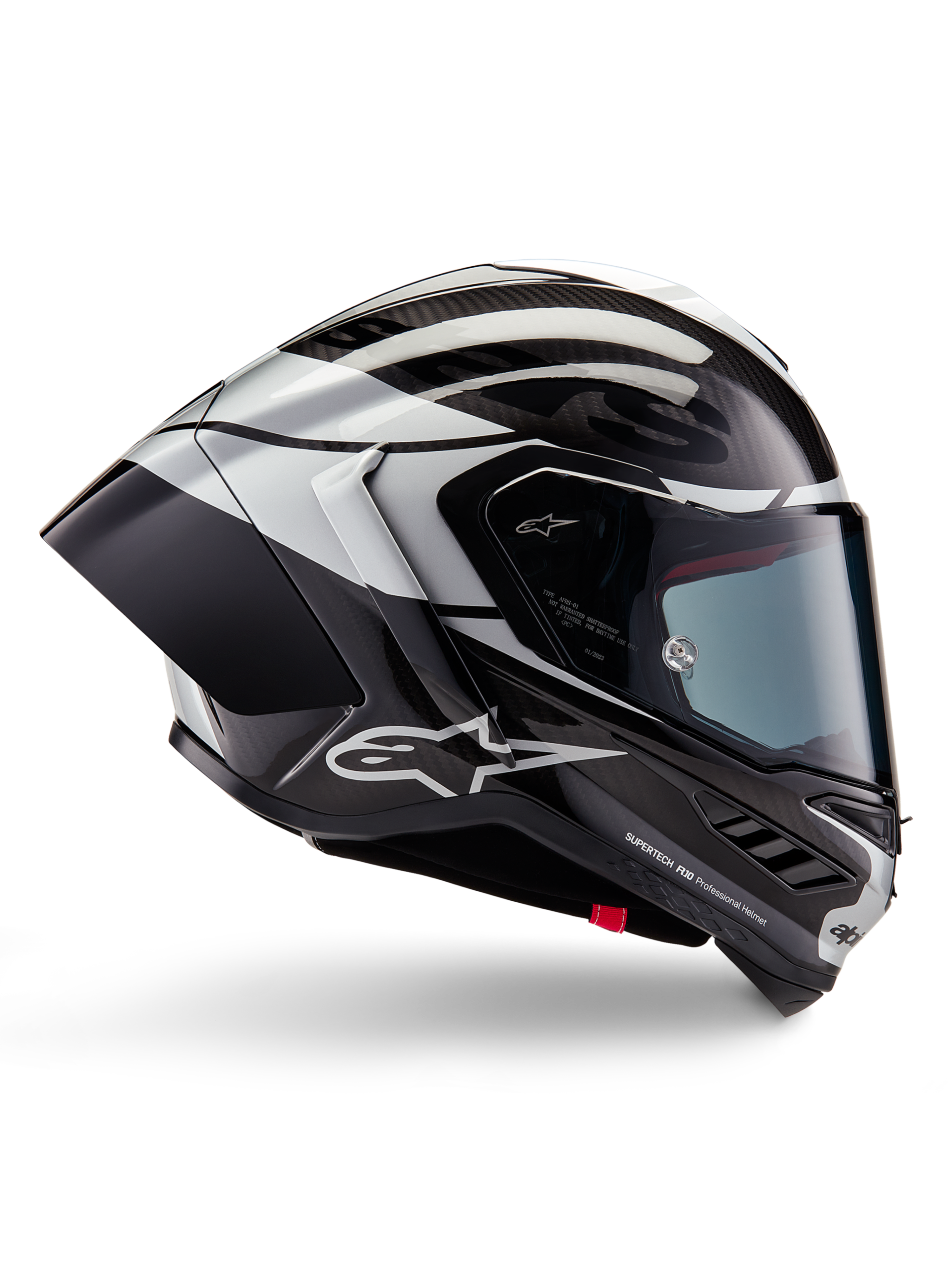 Kask Alpinestars Supertech R10 Element, integralny kask wyścigowy, wykończenie Black Carbon, srebrne i czarne z połyskiem, widok z boku z aerodynamiczną skorupą z włókna węglowego, przezroczystym wizjerem i wyraźnym logo Alpinestars