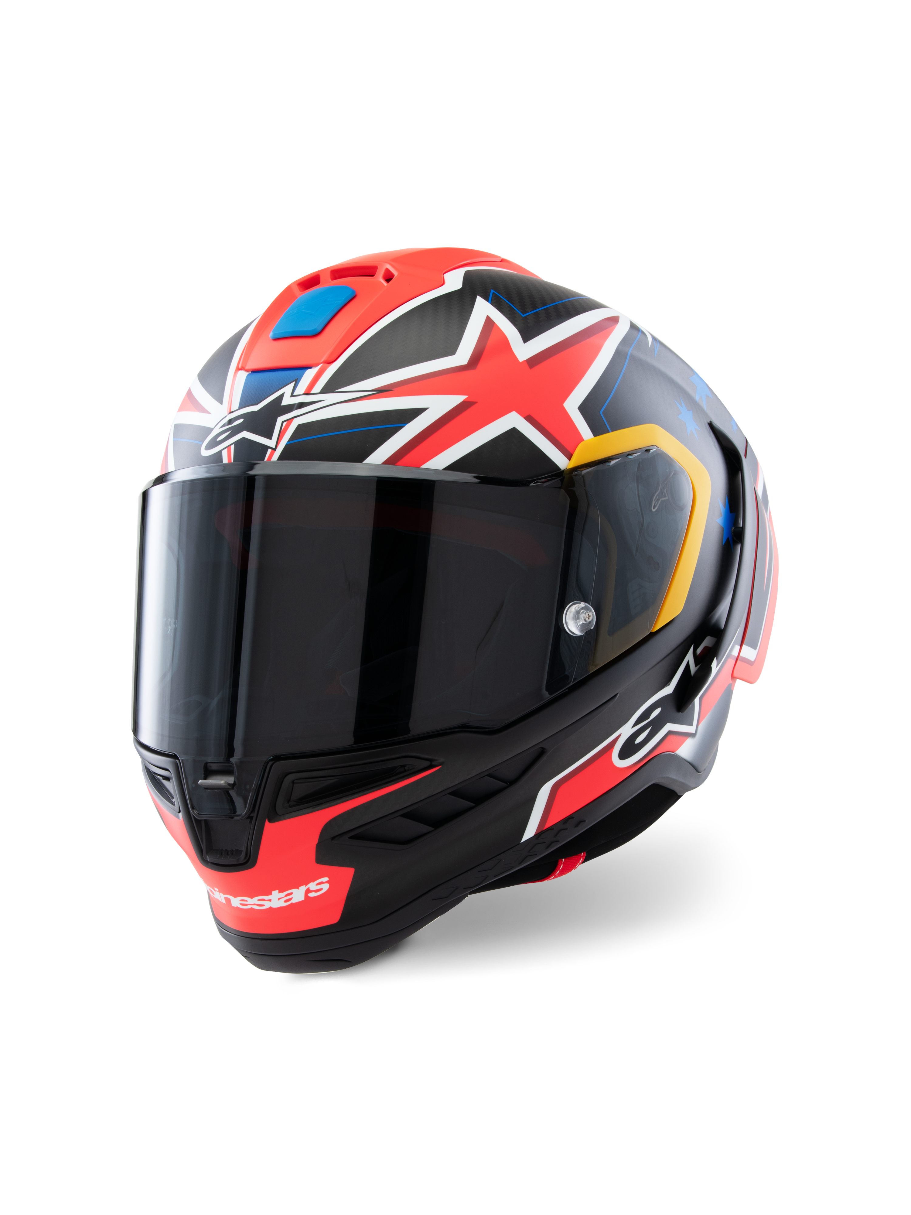 Kask Alpinestars Supertech R10 Miller Limited Edition, pełnotwarzowy kask wyścigowy, Carbon Red Matt z czerwonymi gwiazdami, niebieskie i żółte akcenty graficzne, przyciemniany wizjer, aerodynamiczna skorupa z włókna węglowego do profesjonalnych wyścigów motocyklowych