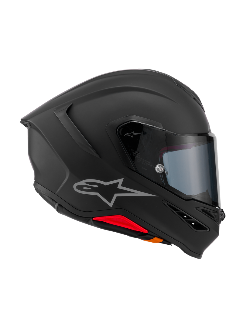 Kask Alpinestars S-R7 Solid, integralny kask motocyklowy, czarny mat, widok z boku prezentujący aerodynamiczną skorupę z kompozytu węglowego, zintegrowany tylny spojler, srebrne logo, przezroczysty wizjer i otwory wentylacyjne, wyścigowy i sportowy sprzęt motocyklowy