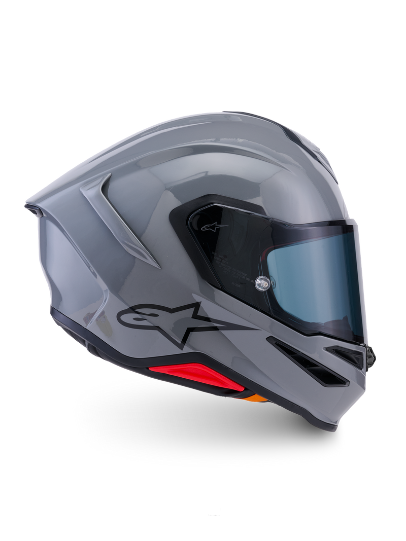 Alpinestars S-R7 Solid Helmet, integralny kask motocyklowy, szary błyszczący, widok z boku, błyszcząca szara aerodynamiczna skorupa z czarnym logo i czerwonymi akcentami u podstawy, wysokiej klasy sprzęt do wyścigów i jazdy sportowej