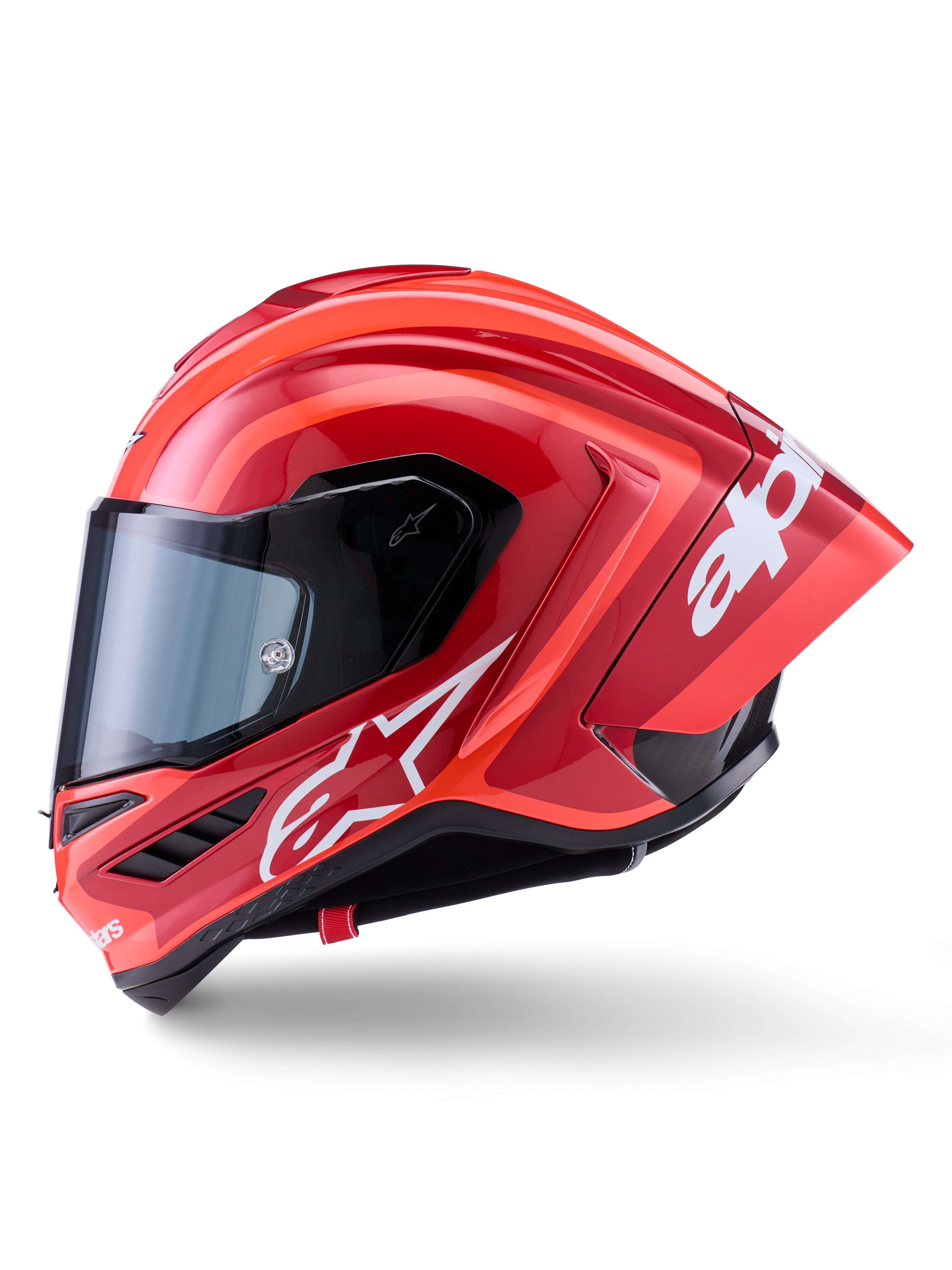 Kask Alpinestars Supertech R10 Arius, wyścigowy kask typu full-face, błyszczący czerwony z białymi grafikami logo, widok z boku podkreślający aerodynamiczny spojler i przezroczysty wizjer, skorupa z kompozytu włókna węglowego do profesjonalnych sportów motorowych