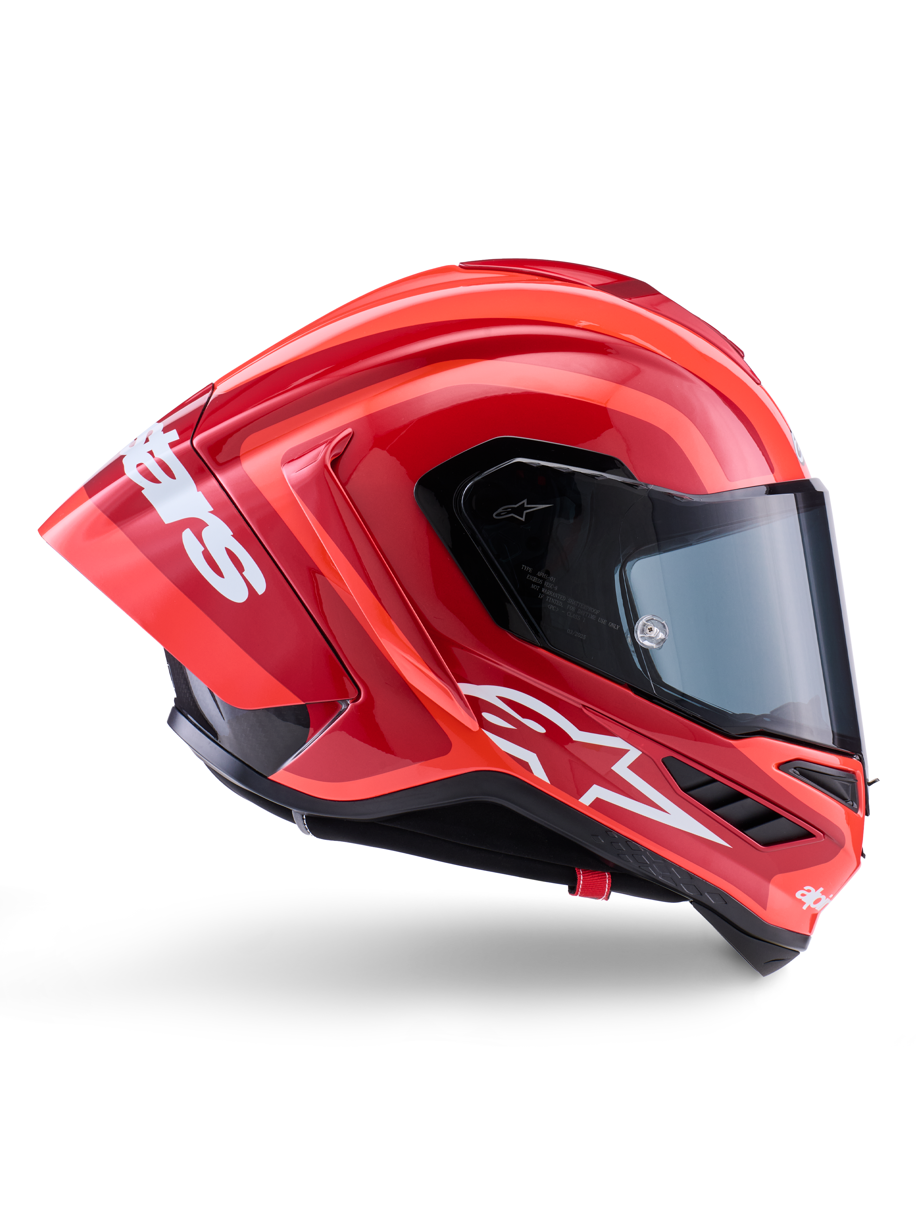 Kask Alpinestars Supertech R10 Arius, integralny kask wyścigowy, błyszczący czerwony i pomarańczowy, widok z boku prezentujący aerodynamiczny tylny spojler, białe logo Astars na szczęce i przezroczysty wizjer, zaprojektowany z myślą o wysokich osiągach na torze