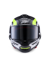 Alpinestars Supertech R10 Arius Helmet, wyścigowy kask motocyklowy, czarny, srebrny i żółty fluo z połyskiem, widok z przodu przedstawiający skorupę z włókna węglowego, ciemny dymiony wizjer i zintegrowany system wentylacji.