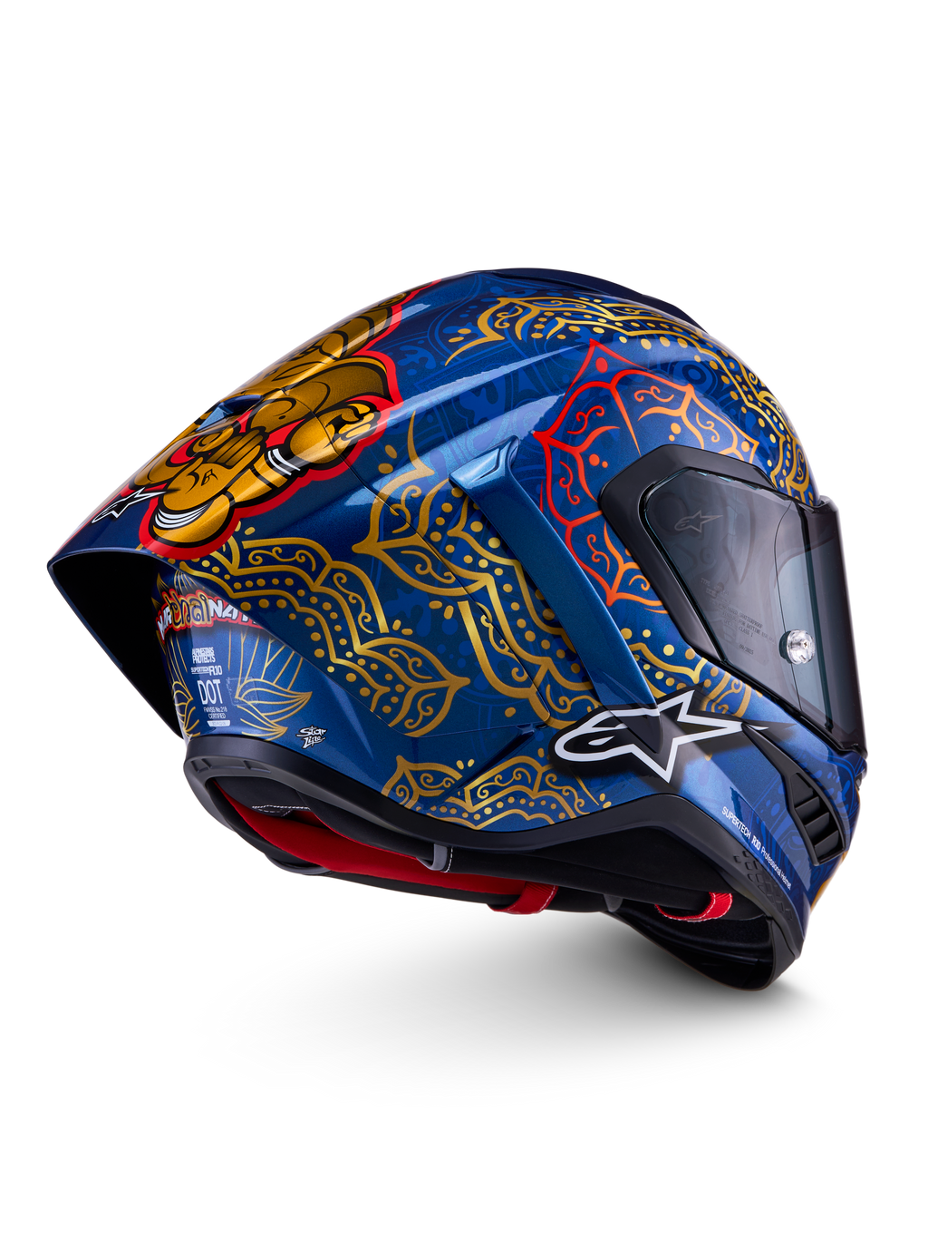 Alpinestars Supertech R10 Martinator Thai, wyścigowy kask motocyklowy, niebieski i złoty, skorupa z włókna węglowego, certyfikaty FIM, ECE i DOT, wzory mandali oraz aerodynamiczny tylny spoiler.