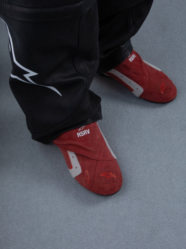 Alpinestars RSRV Starline Shoes, Red lifestyle slippers with white and gray accents, RSRV branding, soft texture, worn with black pants, casual urban footwear