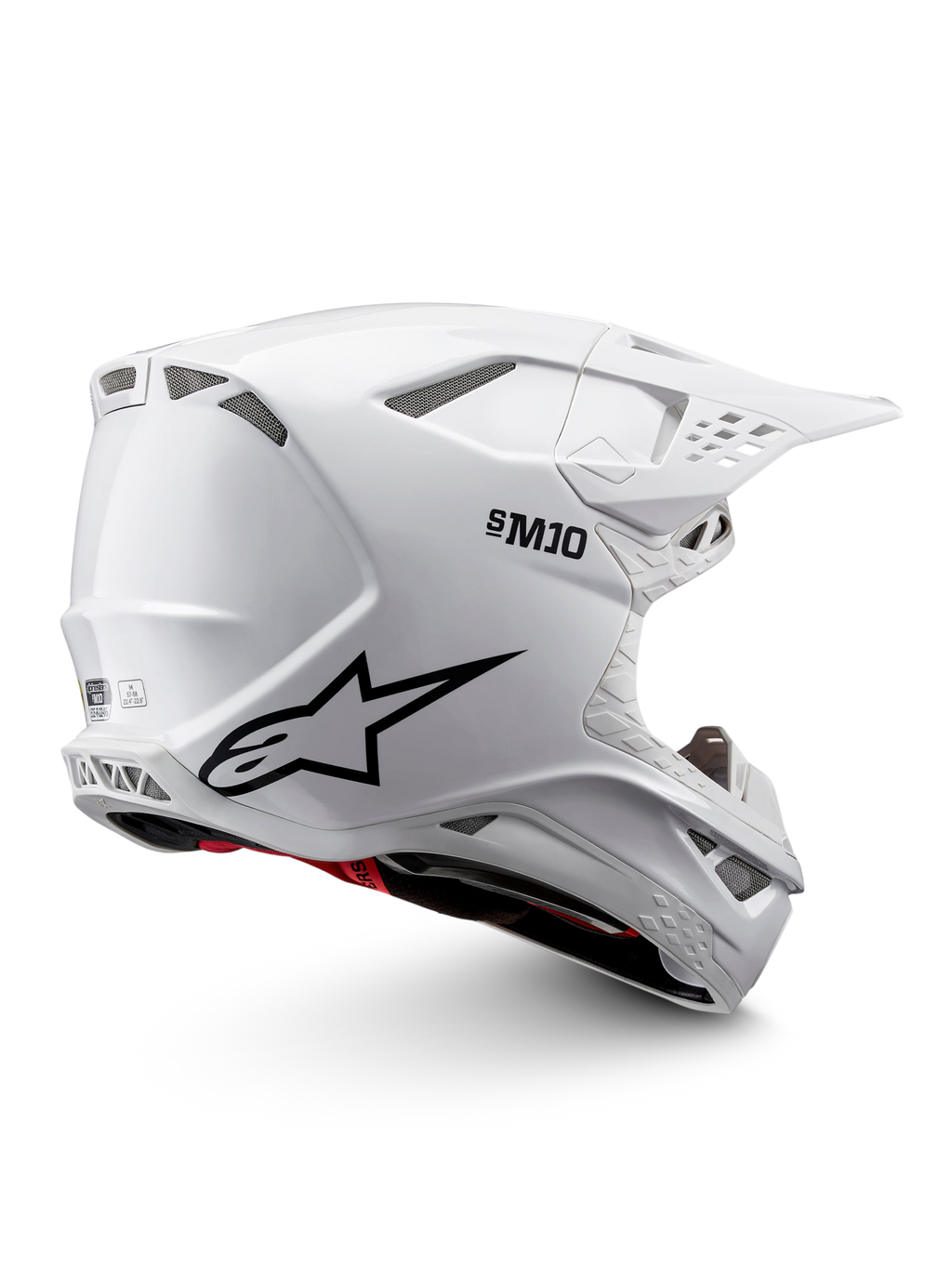 Alpinestars Supertech M10 Solid ECE 22.06, biały błyszczący kask motocrossowy z czarną grafiką, czerwonymi akcentami, otworami wentylacyjnymi i daszkiem