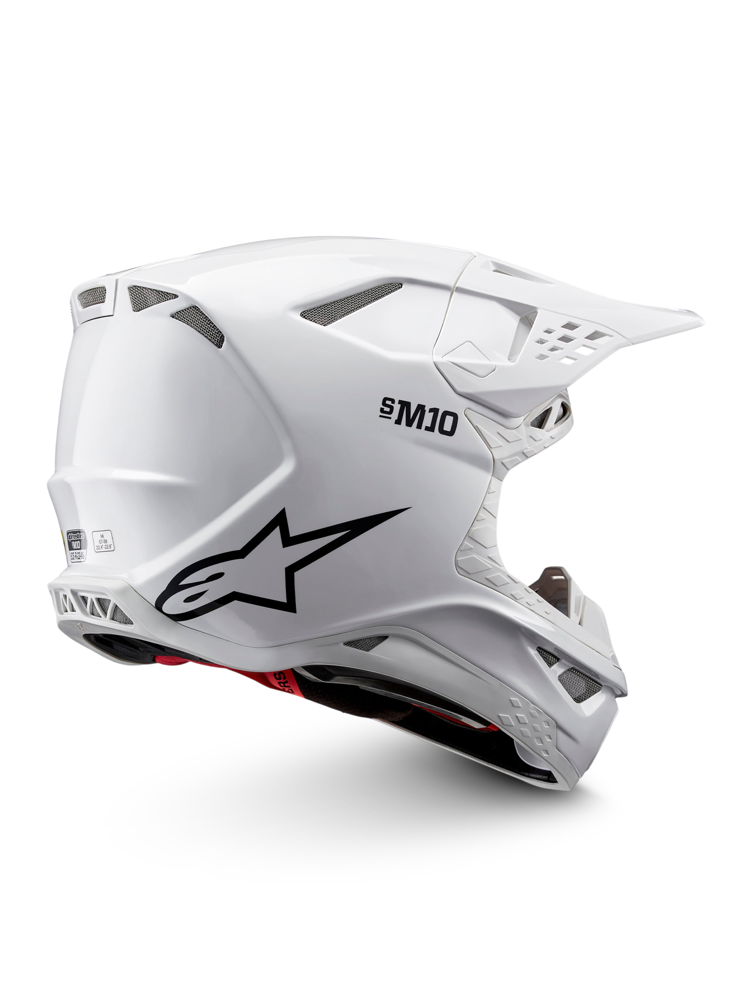 Alpinestars Supertech M10 Solid ECE 22.06, biały błyszczący kask motocrossowy z czarną grafiką, czerwonymi akcentami, otworami wentylacyjnymi i daszkiem