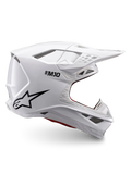 Alpinestars Supertech M10 Solid ECE 22.06, biały błyszczący kask motocrossowy, czarne logo, daszek i wentylowana konstrukcja pełnotwarzowa, certyfikowany ECE 22.06, widok z boku