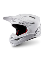 Alpinestars Supertech M10 Solid ECE 22.06, biały błyszczący kask motocrossowy, czarne i czerwone wnętrze, daszek i liczne wloty wentylacyjne, ujęcie z trzech czwartych