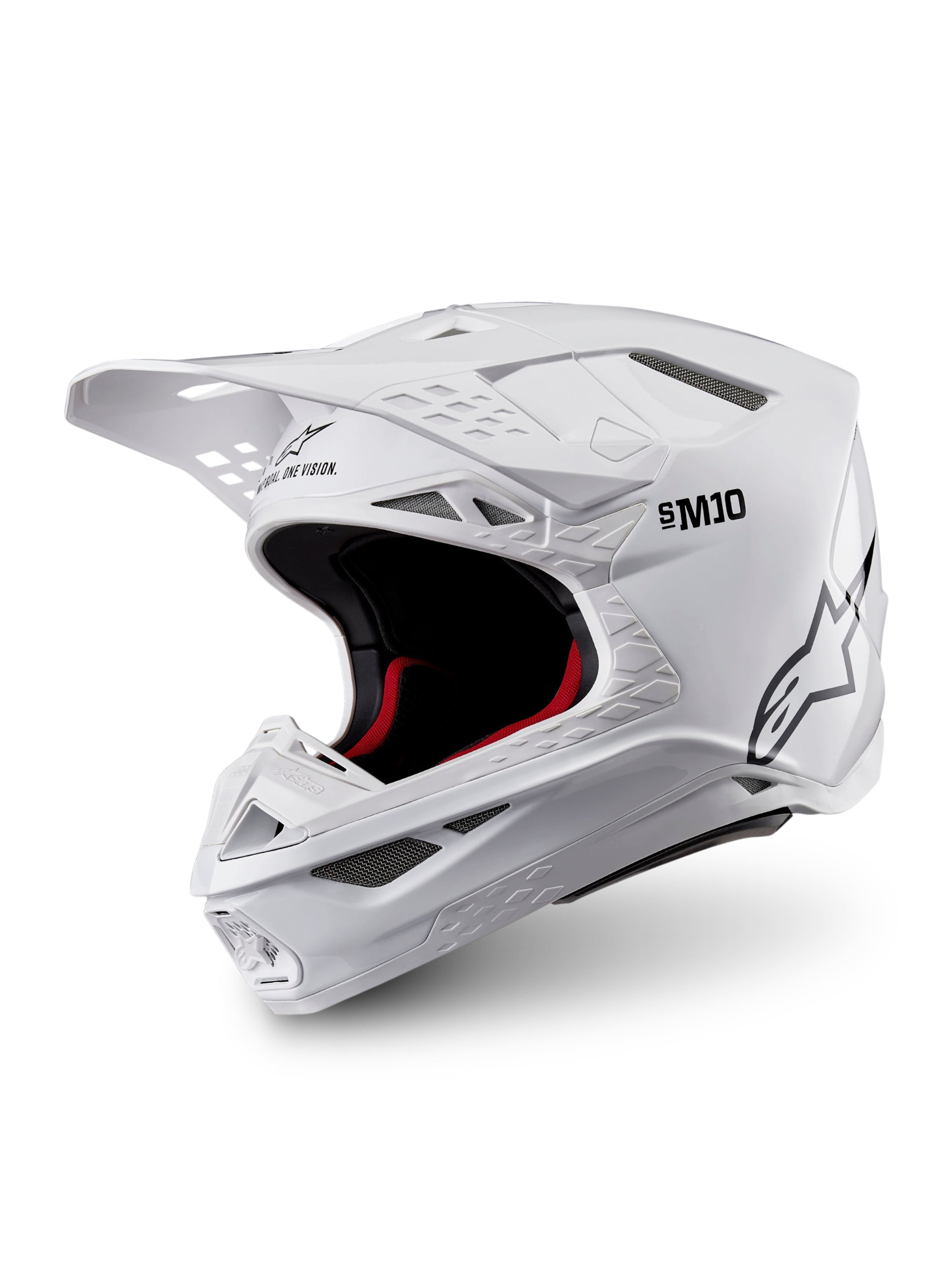 Alpinestars Supertech M10 Solid ECE 22.06, biały błyszczący kask motocrossowy, czarne i czerwone wnętrze, daszek i liczne wloty wentylacyjne, ujęcie z trzech czwartych