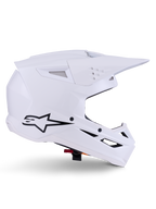 Alpinestars S-M3 Solid Helmet, kask motocrossowy, biały połysk, widok z boku z czarnym logo gwiazdy, kanciasta aerodynamiczna skorupa, liczne otwory wentylacyjne, zintegrowany daszek i osłona szczęki, ochrona do wyścigów terenowych