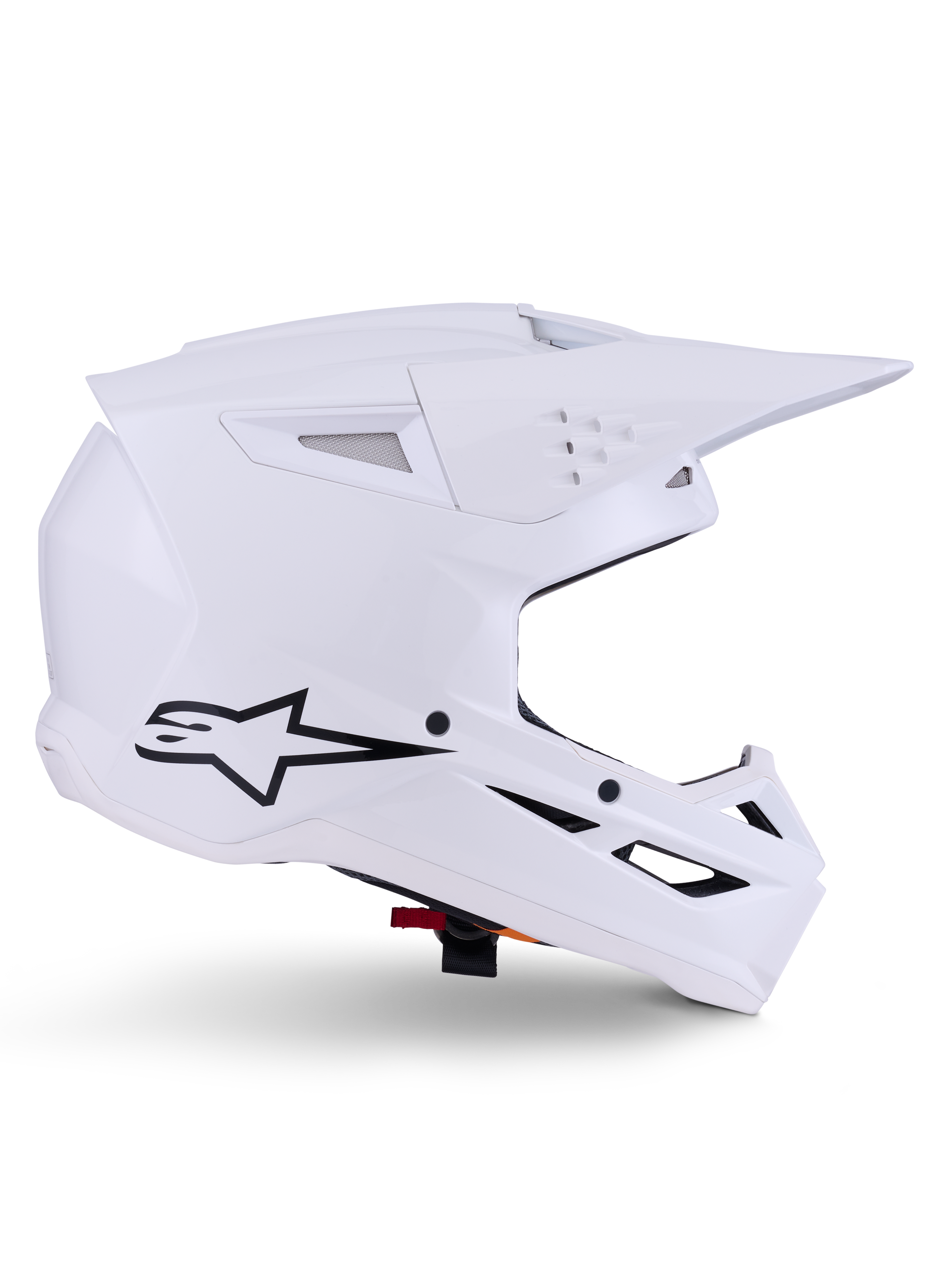 Alpinestars S-M3 Solid Helmet, kask motocrossowy, biały połysk, widok z boku z czarnym logo gwiazdy, kanciasta aerodynamiczna skorupa, liczne otwory wentylacyjne, zintegrowany daszek i osłona szczęki, ochrona do wyścigów terenowych