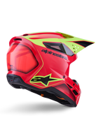 Kask Alpinestars S-M3 Fray ECE 22.06, kask motocrossowy, czerwony, żółty fluo i czarny połysk, widok z tyłu pod kątem ukazujący aerodynamiczną skorupę z licznymi otworami wentylacyjnymi, neonowożółte grafiki i wyraźne czarne logo Alpinestars.