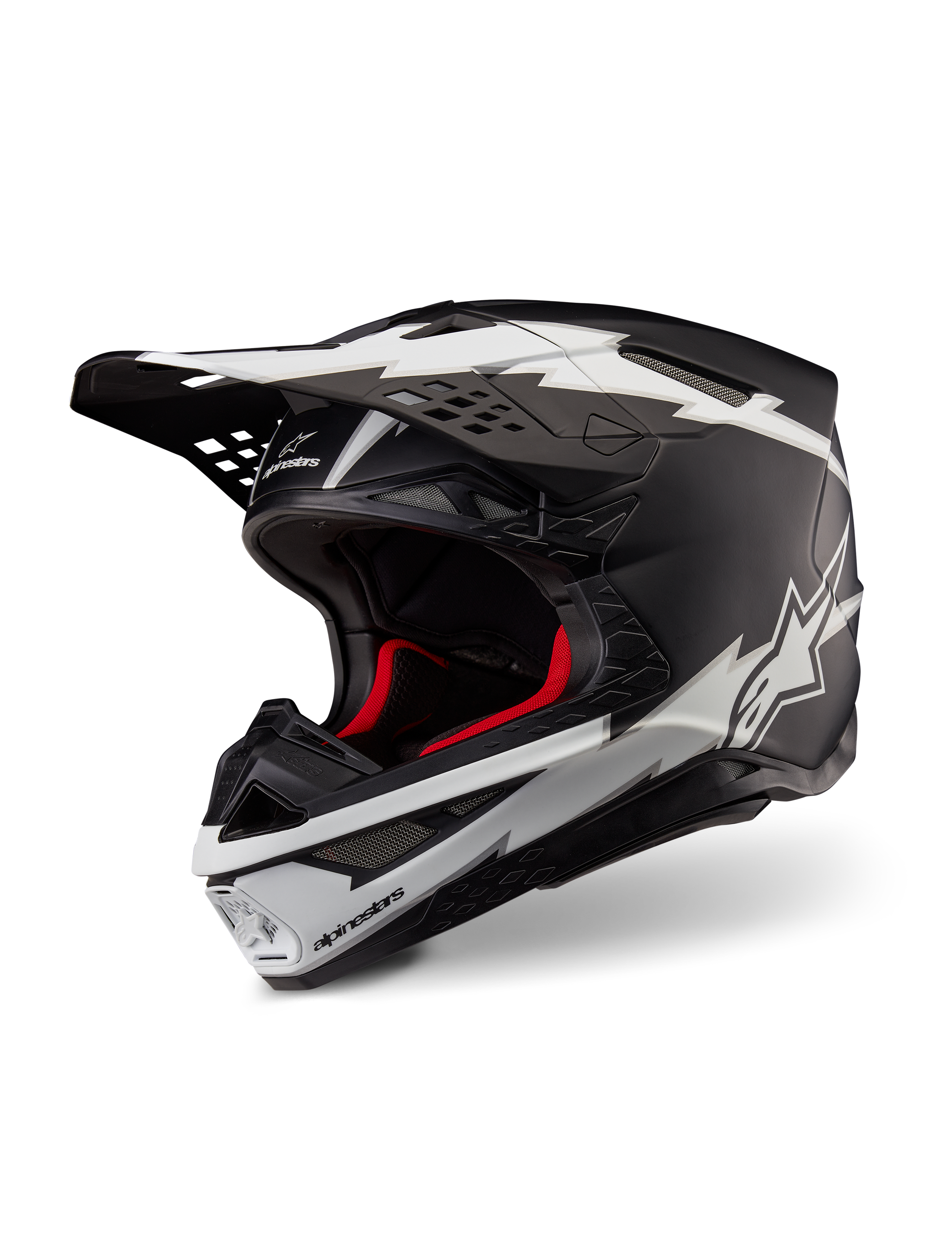 Alpinestars Supertech M10 Ampress Helmet, kask motocrossowy, czarno-biały matowy, z wyrazistymi białymi grafikami w stylu błyskawic i logo gwiazdy, czerwona wyściółka wewnętrzna, wielokompozytowa skorupa z włókna węglowego o aerodynamicznym profilu