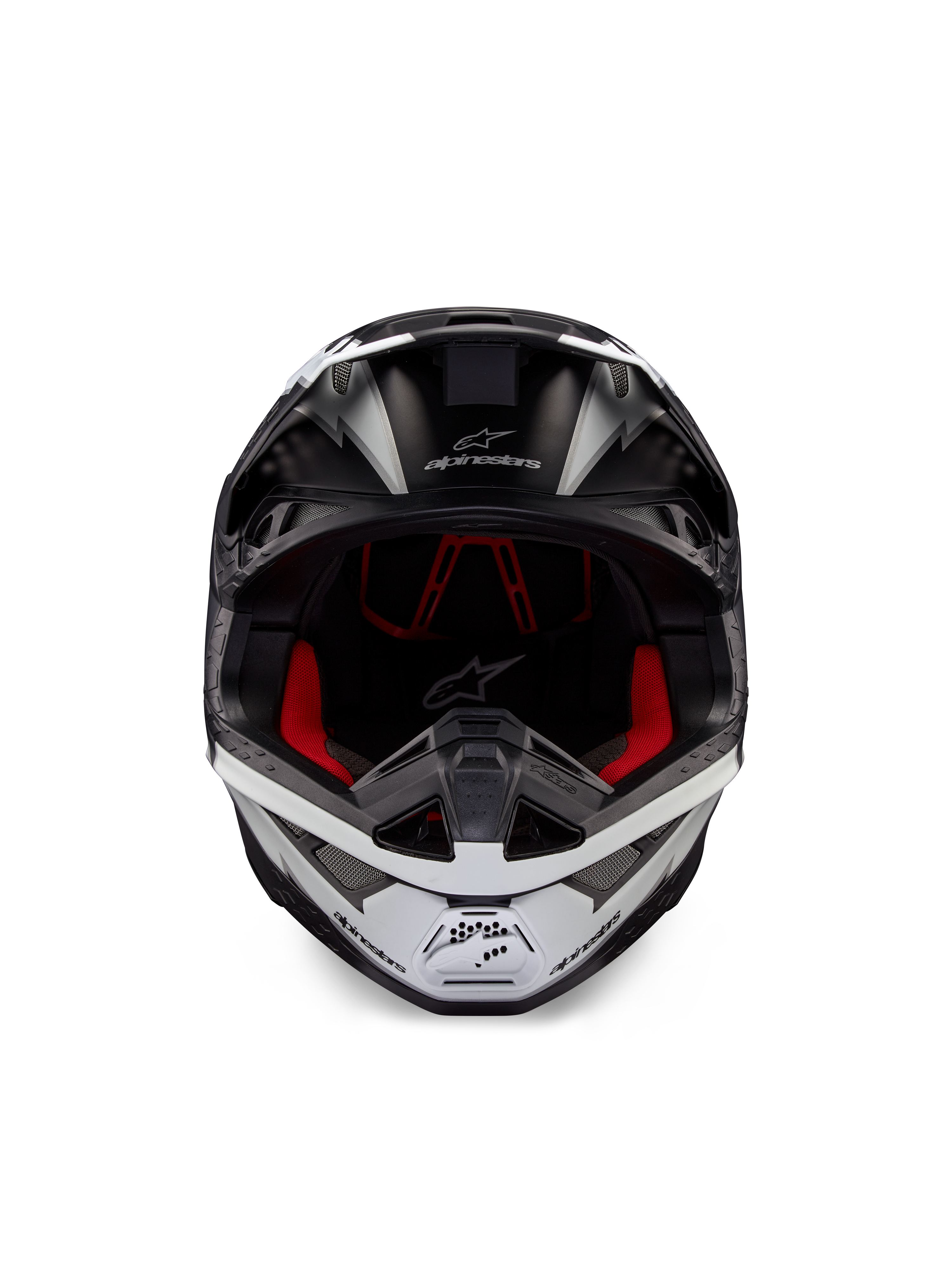 Kask Alpinestars Supertech M10 Ampress, kask motocrossowy, czarno-biały matowy, widok z przodu z czerwoną wyściółką wewnętrzną, aerodynamiczna skorupa z otworami wentylacyjnymi i logo Alpinestars