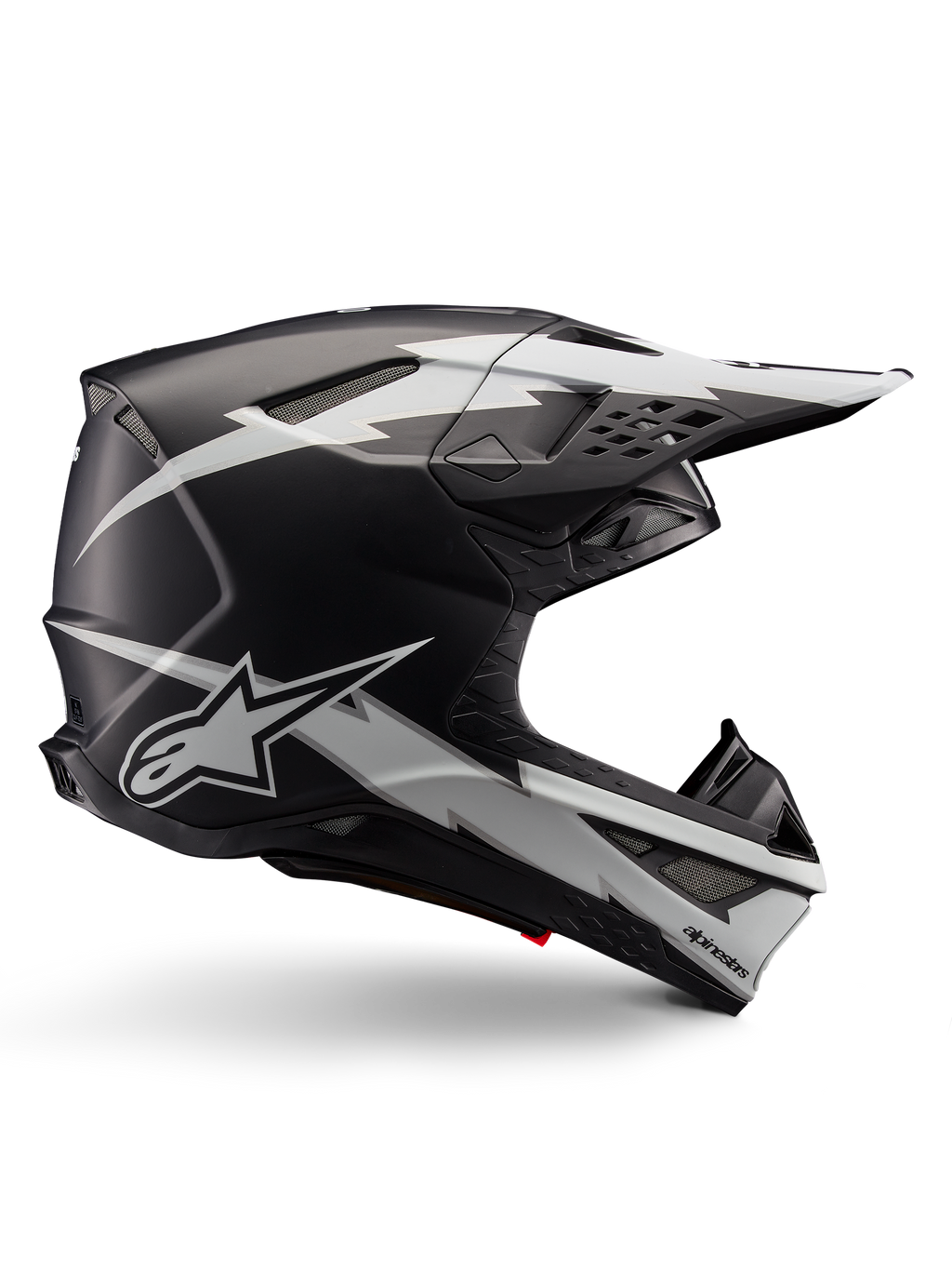 Alpinestars Supertech M10 Ampress Helmet, kask motocrossowy, czarny i biały matowy, aerodynamiczny profil z grafikami białych błyskawic, liczne otwory wentylacyjne, przedłużony daszek, konstrukcja z włókna węglowego z matowym wykończeniem