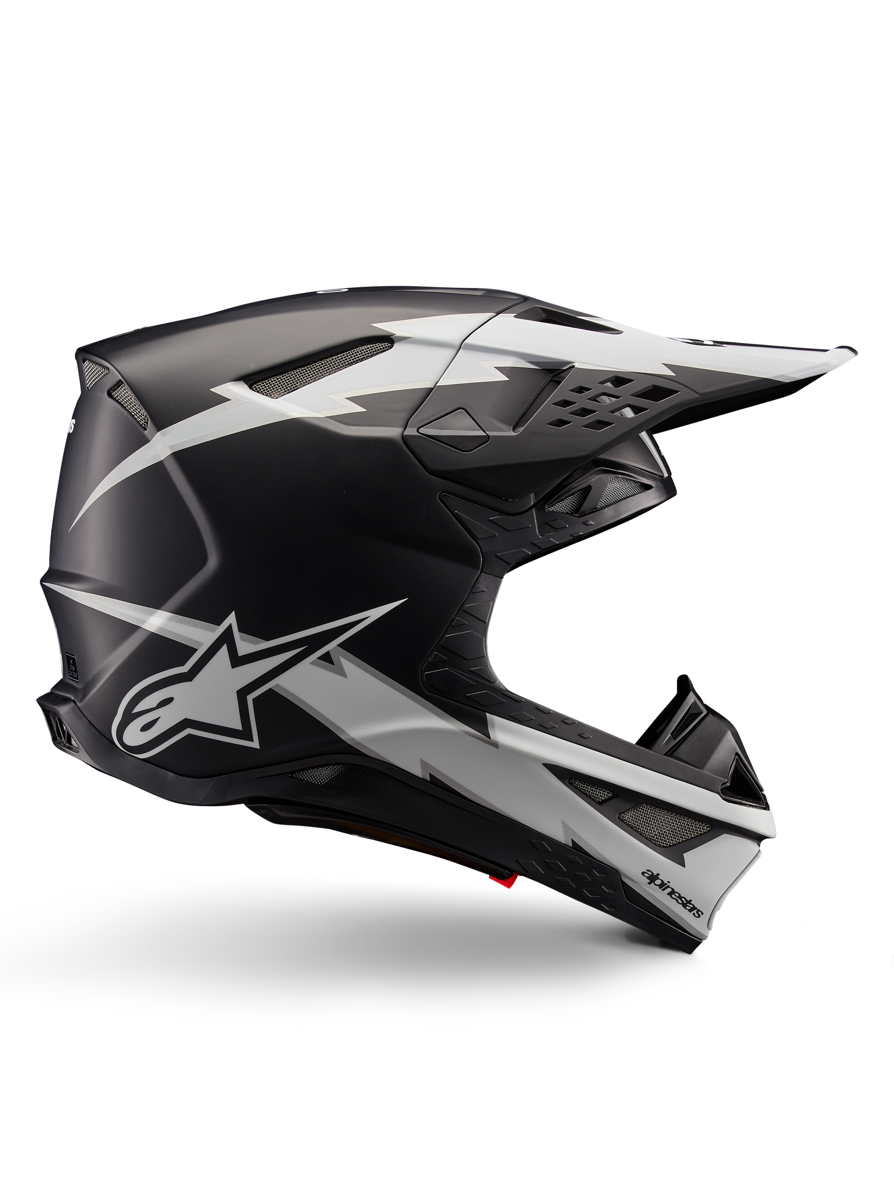Alpinestars Supertech M10 Ampress Helmet, kask motocrossowy, czarny i biały matowy, aerodynamiczny profil z grafikami białych błyskawic, liczne otwory wentylacyjne, przedłużony daszek, konstrukcja z włókna węglowego z matowym wykończeniem