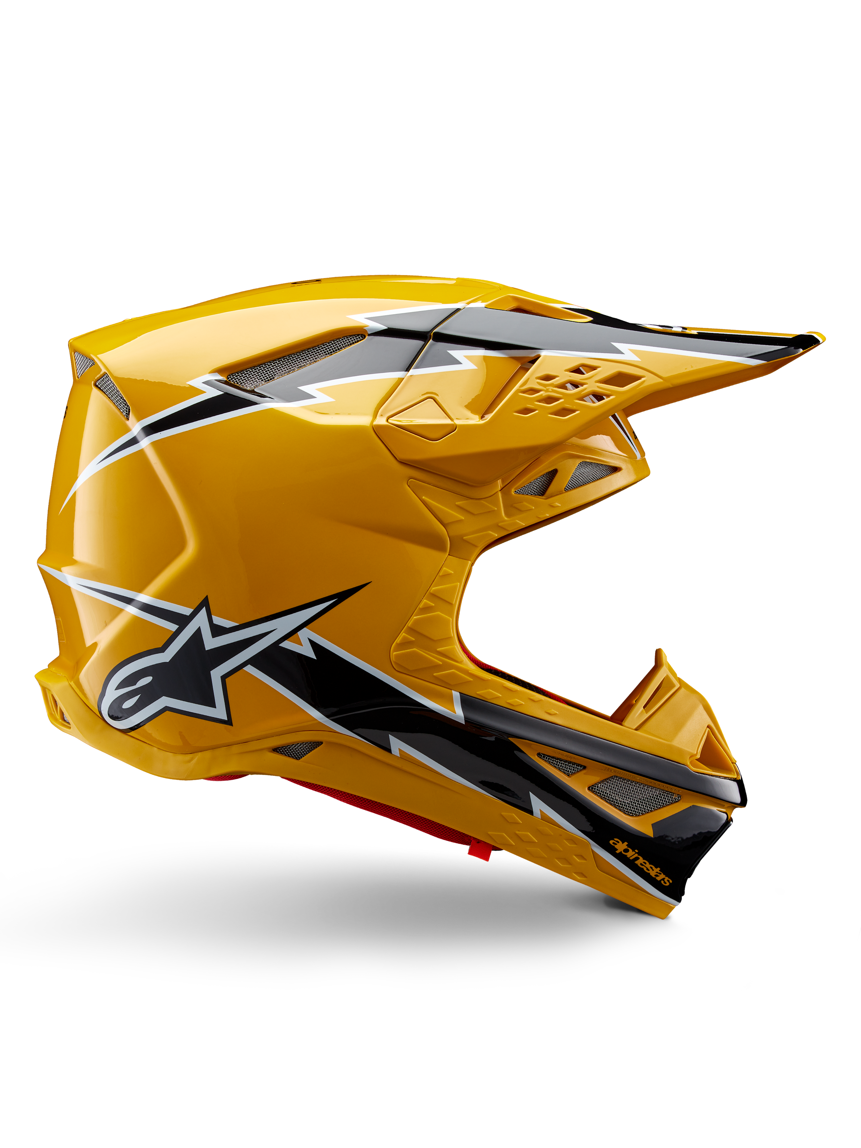 Kask Alpinestars Supertech M10 Ampress, kask motocrossowy, żółto-czarny błyszczący, profil boczny prezentujący wyraźne czarno-białe grafiki błyskawic, logo gwiazdy Alpinestars, aerodynamiczny design ze zintegrowanymi otworami wentylacyjnymi i regulowanym daszkiem.