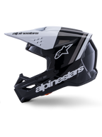 Alpinestars S-M3 Radium Helmet ECE 22.06, widok z profilu, błyszczące czarno-białe wykończenie, szare paski wyścigowe, białe logo Alpinestars z boku i na szczęce, wentylowana konstrukcja do motocrossu i enduro