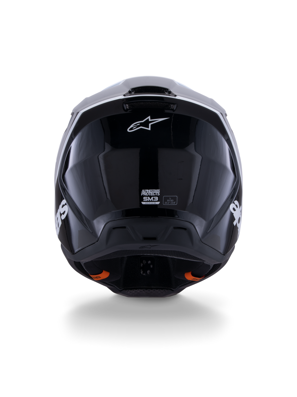 Kask Alpinestars S-M3 Radium ECE 22.06, kask motocrossowy, czarno-biało-szary z połyskiem, widok z tyłu prezentujący błyszczące czarne wykończenie, logo gwiazdy Alpinestars, otwory wylotowe wentylacji oraz etykietę certyfikacji ECE