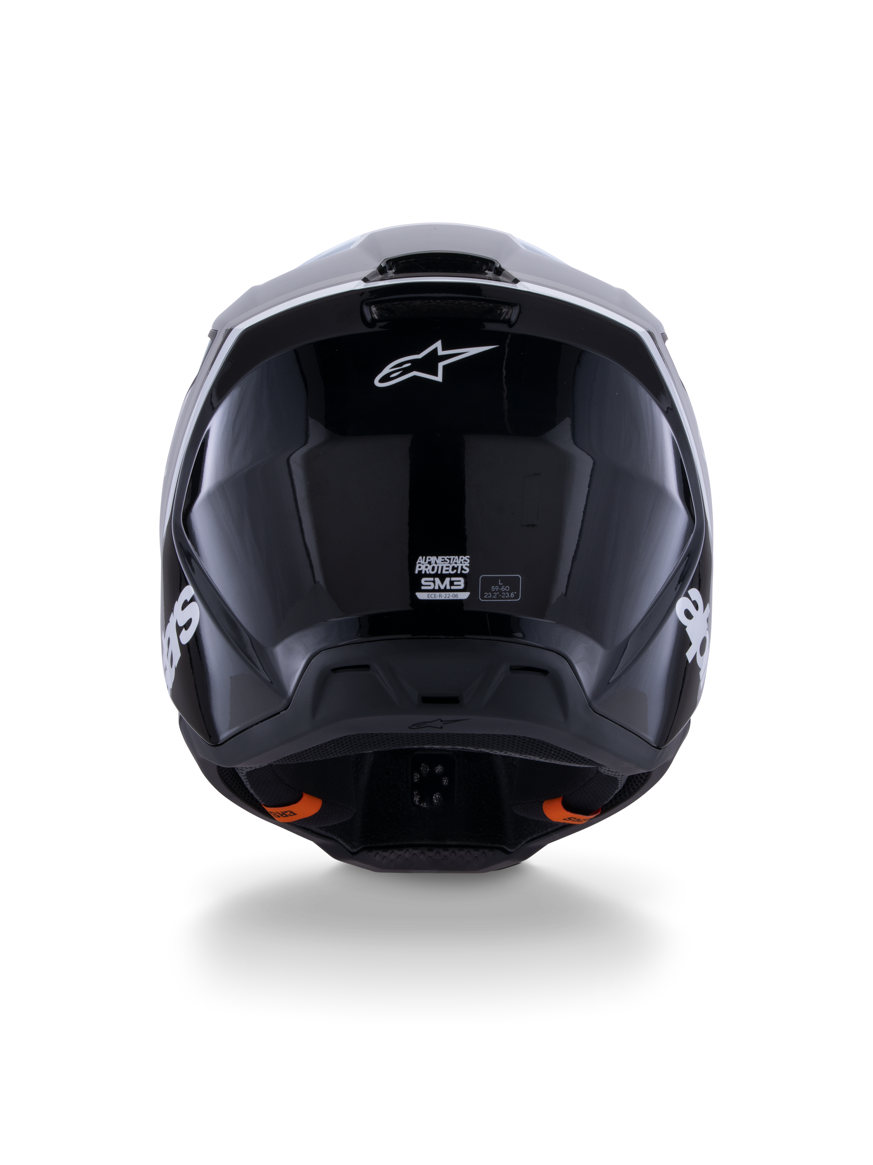Kask Alpinestars S-M3 Radium ECE 22.06, kask motocrossowy, czarno-biało-szary z połyskiem, widok z tyłu prezentujący błyszczące czarne wykończenie, logo gwiazdy Alpinestars, otwory wylotowe wentylacji oraz etykietę certyfikacji ECE