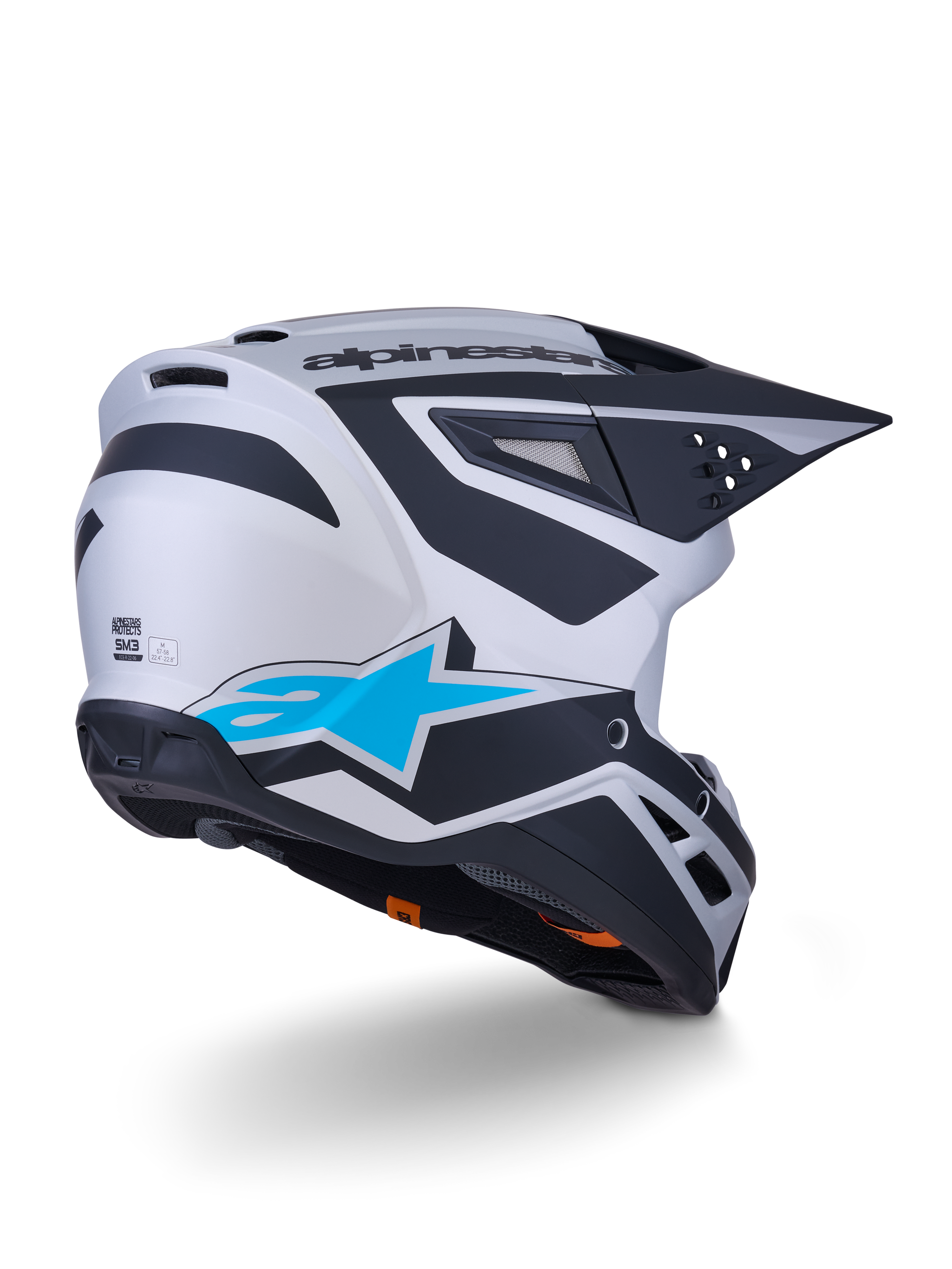 Alpinestars S-M3 Heat Helmet ECE 22.06, kask motocrossowy, srebrno-niebieski i czarny mat, widok z tyłu z dużym niebieskim logo gwiazdy i czarnymi kanciastymi wzorami, aerodynamiczna skorupa z otworami wentylacyjnymi, wysokowydajna ochrona do wyścigów off-road