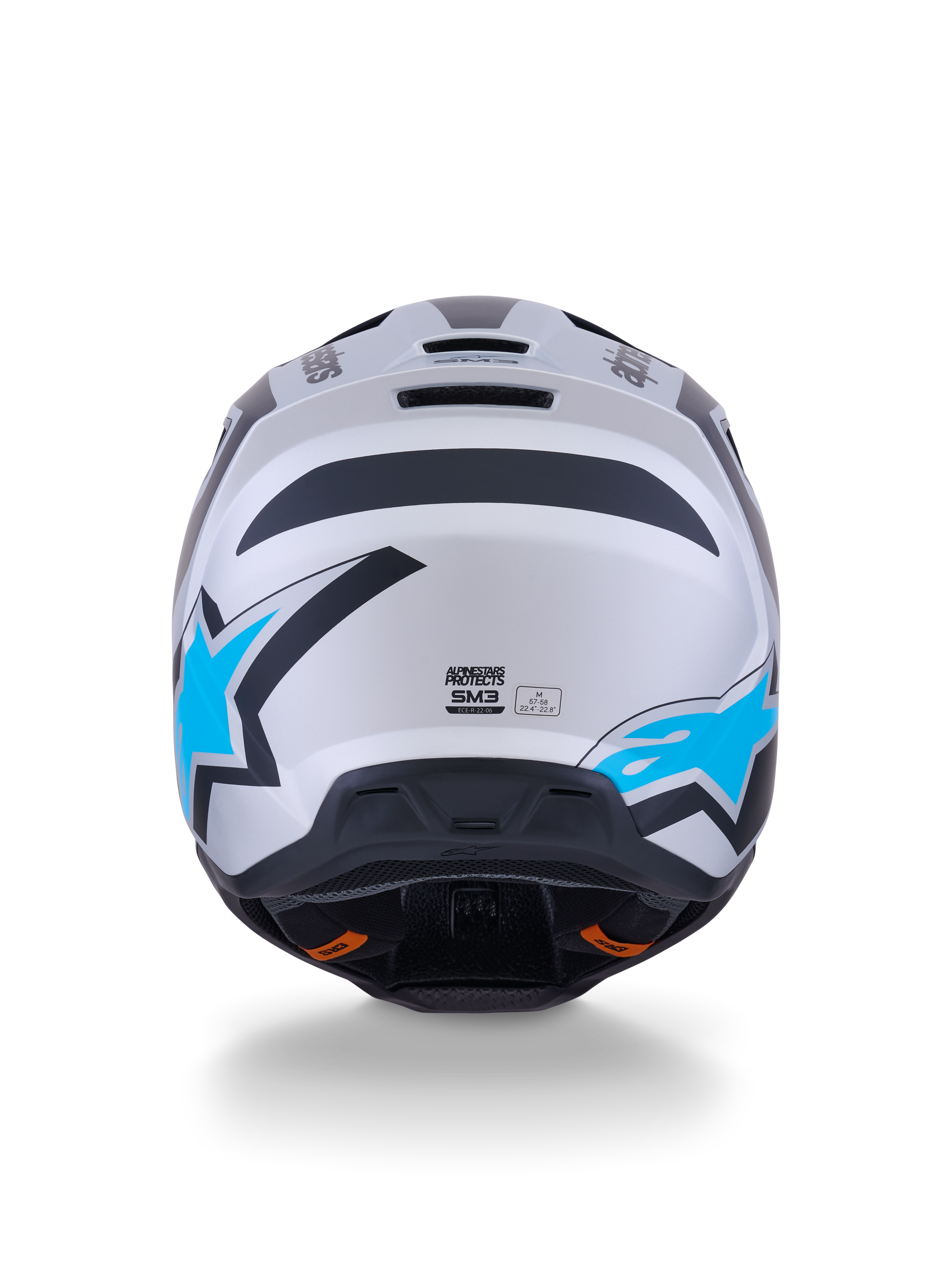 Kask Alpinestars S-M3 Heat, kask motocrossowy, srebrno-niebiesko-czarny mat, widok z tyłu ukazujący jasnoniebieskie logo z gwiazdą, matowe wykończenie i zintegrowane otwory wentylacyjne.