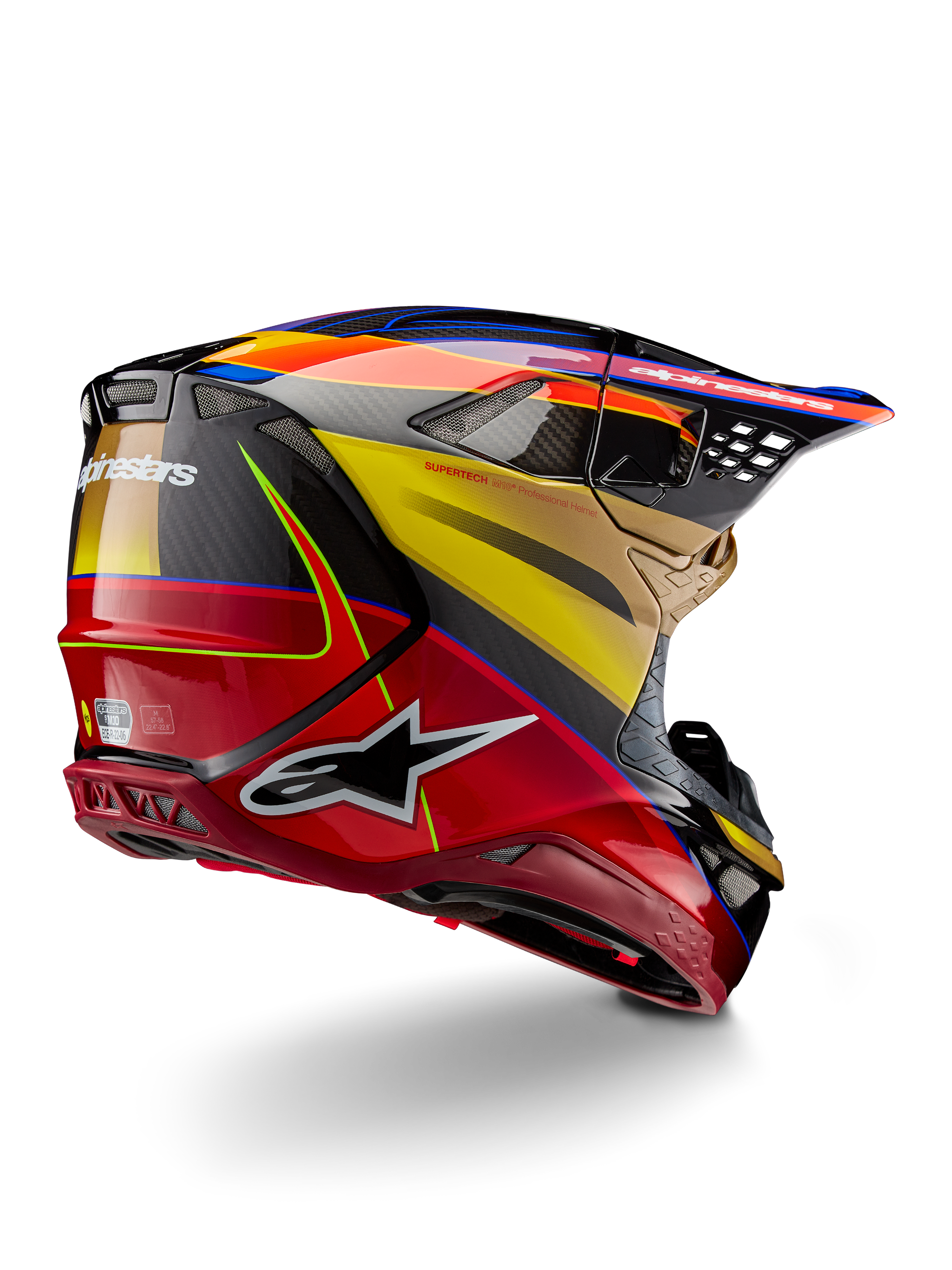 Alpinestars Supertech M10 Era, kask motocrossowy, złoto-żółty i czerwony Rio z połyskiem, widok z tyłu pod kątem trzech czwartych ukazujący skorupę z włókna węglowego, czerwone i żółte grafiki, niebieskie akcenty, aerodynamiczny profil, liczne otwory wentylacyjne i logo Astar