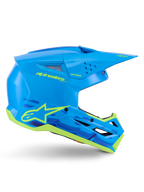 Kask Alpinestars S-M3 Force OCD, motocrossowy kask terenowy, błyszczący cyjan z neonowożółtymi detalami, certyfikat ECE 22.06, aerodynamiczna skorupa z otworami wentylacyjnymi, spiczasty daszek i grafiki z logo gwiazdy