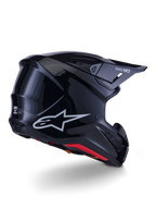 Alpinestars S-M7 Solid Helmet, kask motocrossowy, czarny połysk, z aerodynamiczną skorupą, srebrnym logo Astars, czerwonym wykończeniem wnętrza i zintegrowanymi otworami wentylacyjnymi, zaprojektowany dla ochrony w wyścigach off-road