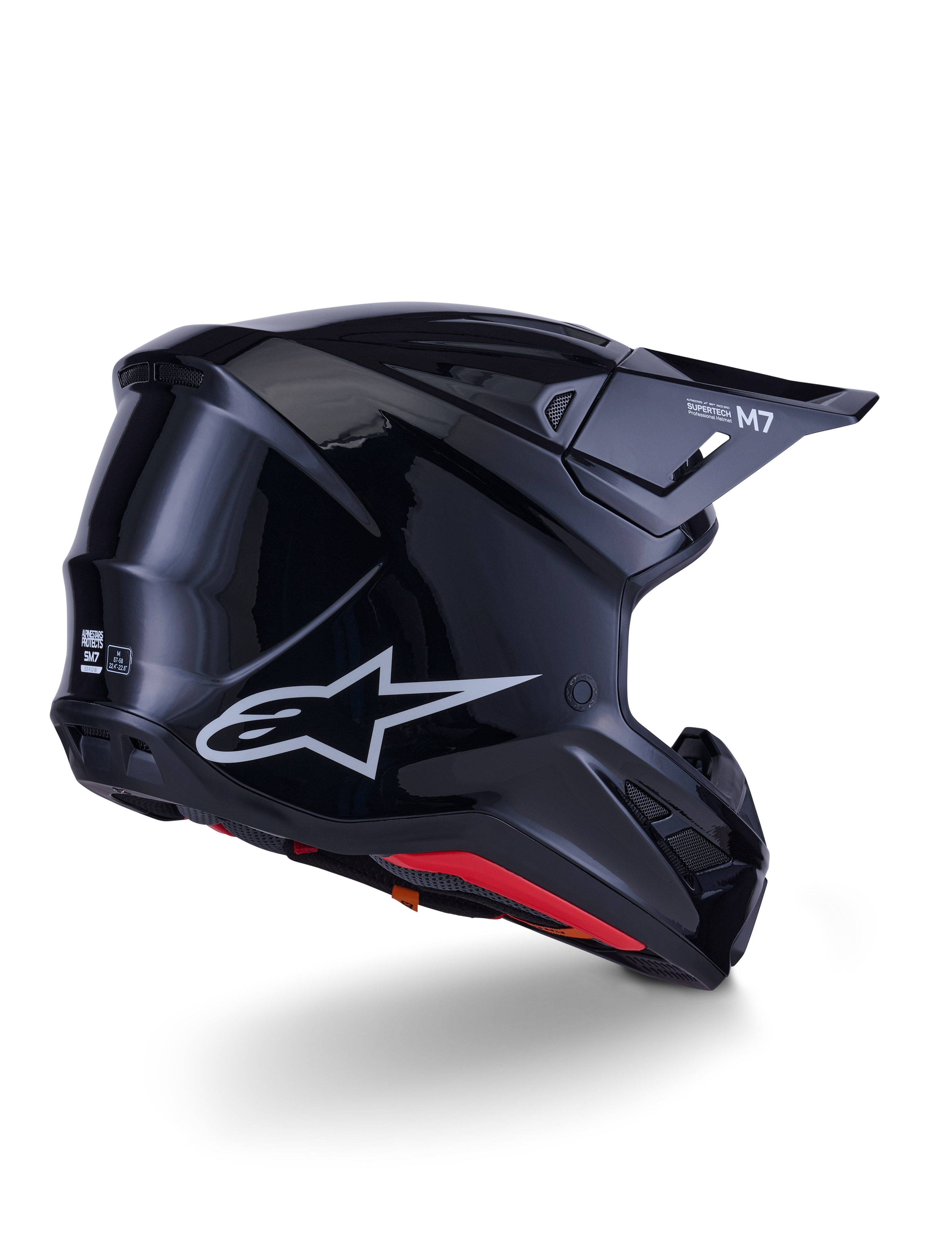 Alpinestars S-M7 Solid Helmet, kask motocrossowy, czarny połysk, z aerodynamiczną skorupą, srebrnym logo Astars, czerwonym wykończeniem wnętrza i zintegrowanymi otworami wentylacyjnymi, zaprojektowany dla ochrony w wyścigach off-road