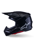 Alpinestars S-M7 Solid Helmet, kask motocrossowy w kolorze błyszczącej czerni, profil boczny z białym logo Alpinestars, aerodynamiczna skorupa z siatką wentylacyjną i czerwoną wyściółką wewnętrzną, zaawansowana ochrona off-road