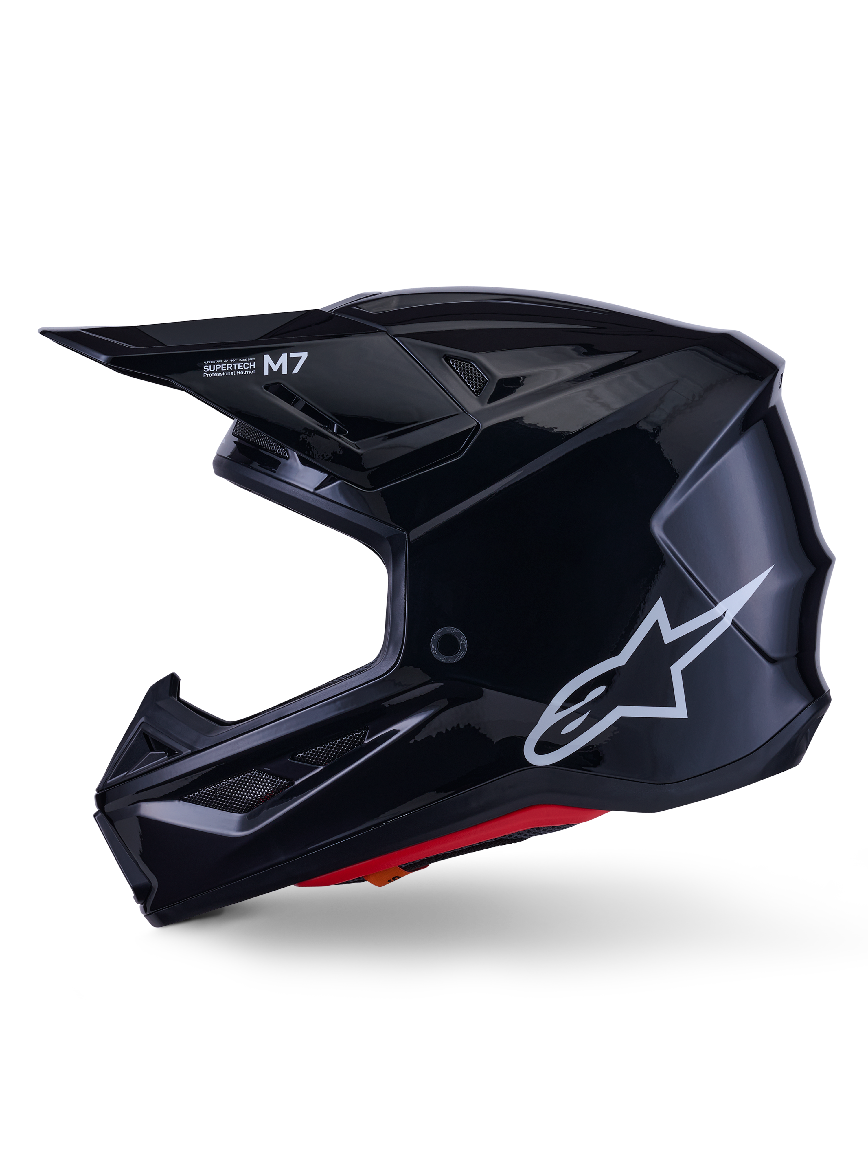 Alpinestars S-M7 Solid Helmet, kask motocrossowy w kolorze błyszczącej czerni, profil boczny z białym logo Alpinestars, aerodynamiczna skorupa z siatką wentylacyjną i czerwoną wyściółką wewnętrzną, zaawansowana ochrona off-road