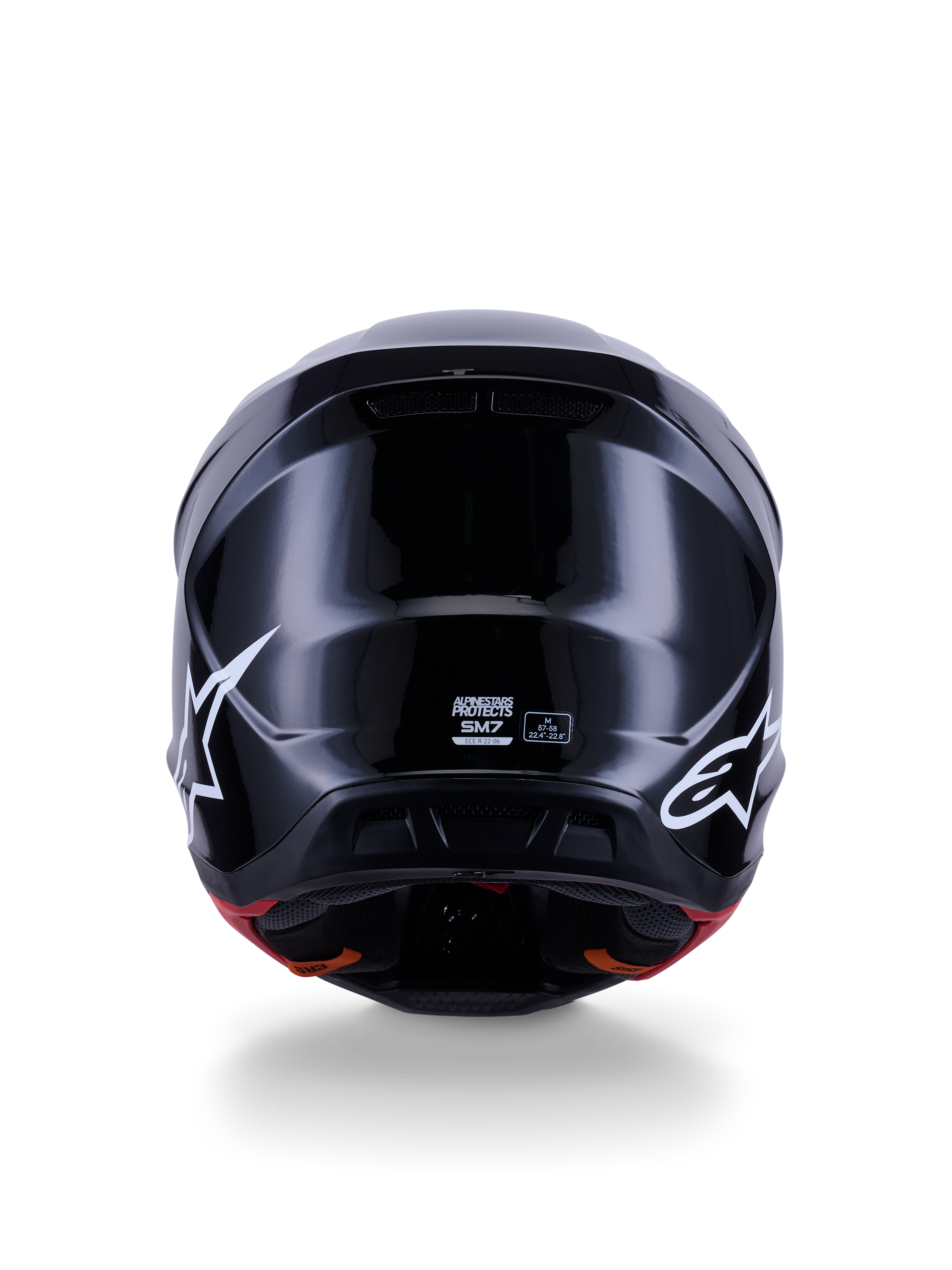 Alpinestars S-M7 Solid Helmet ECE 22.06, kask motocrossowy, czarny połysk, widok z tyłu z białymi logo gwiazdy, aerodynamiczna kompozytowa skorupa z wykończeniem na wysoki połysk, certyfikat bezpieczeństwa i oznaczenie rozmiaru na środku