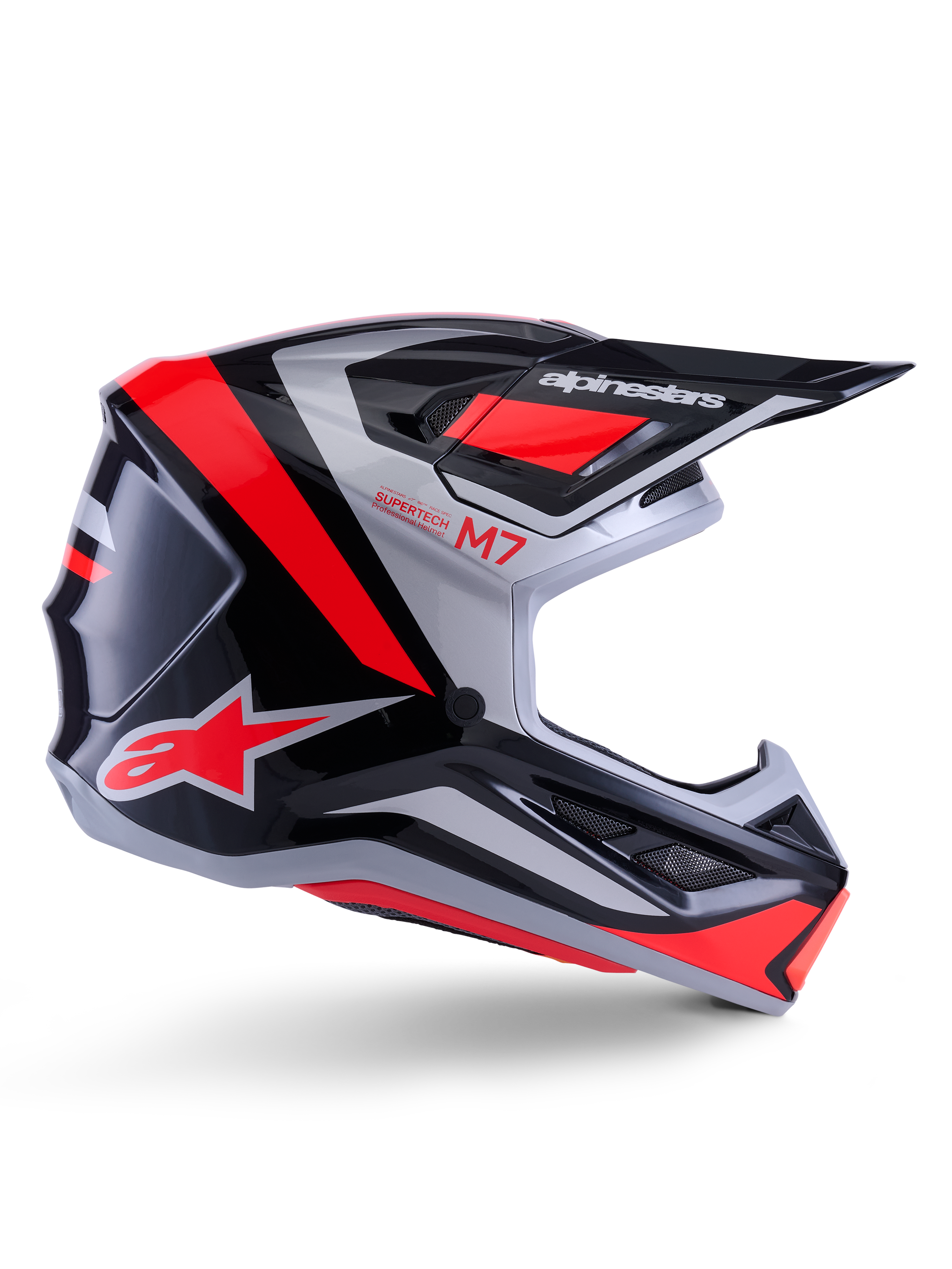 Alpinestars S-M7 Rise Helmet, kask motocrossowy, czarny, srebrny i czerwony fluo, widok z boku ukazujący kanciasty aerodynamiczny design z daszkiem i otworami wentylacyjnymi, błyszczące wykończenie, seria Supertech M7