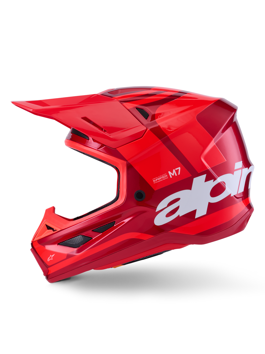 Kask Alpinestars S-M7 Core, czerwony błyszczący z geometrycznymi akcentami, kask motocrossowy, widok z profilu, aerodynamiczna skorupa z otworami wentylacyjnymi i białym logo, wysokiej klasy wyczynowy sprzęt off-road