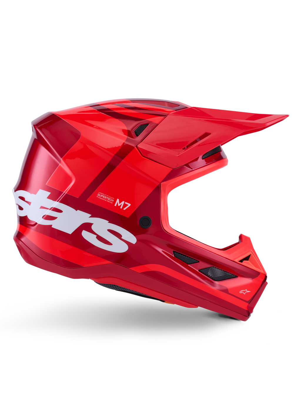 Kask Alpinestars S-M7 Core, kask motocrossowy, błyszczący czerwony z ciemnoczerwonymi akcentami i białym brandingiem, widok z boku z dużym białym logo stars, aerodynamiczna skorupa z siatkowymi otworami wentylacyjnymi i wyraźnym daszkiem