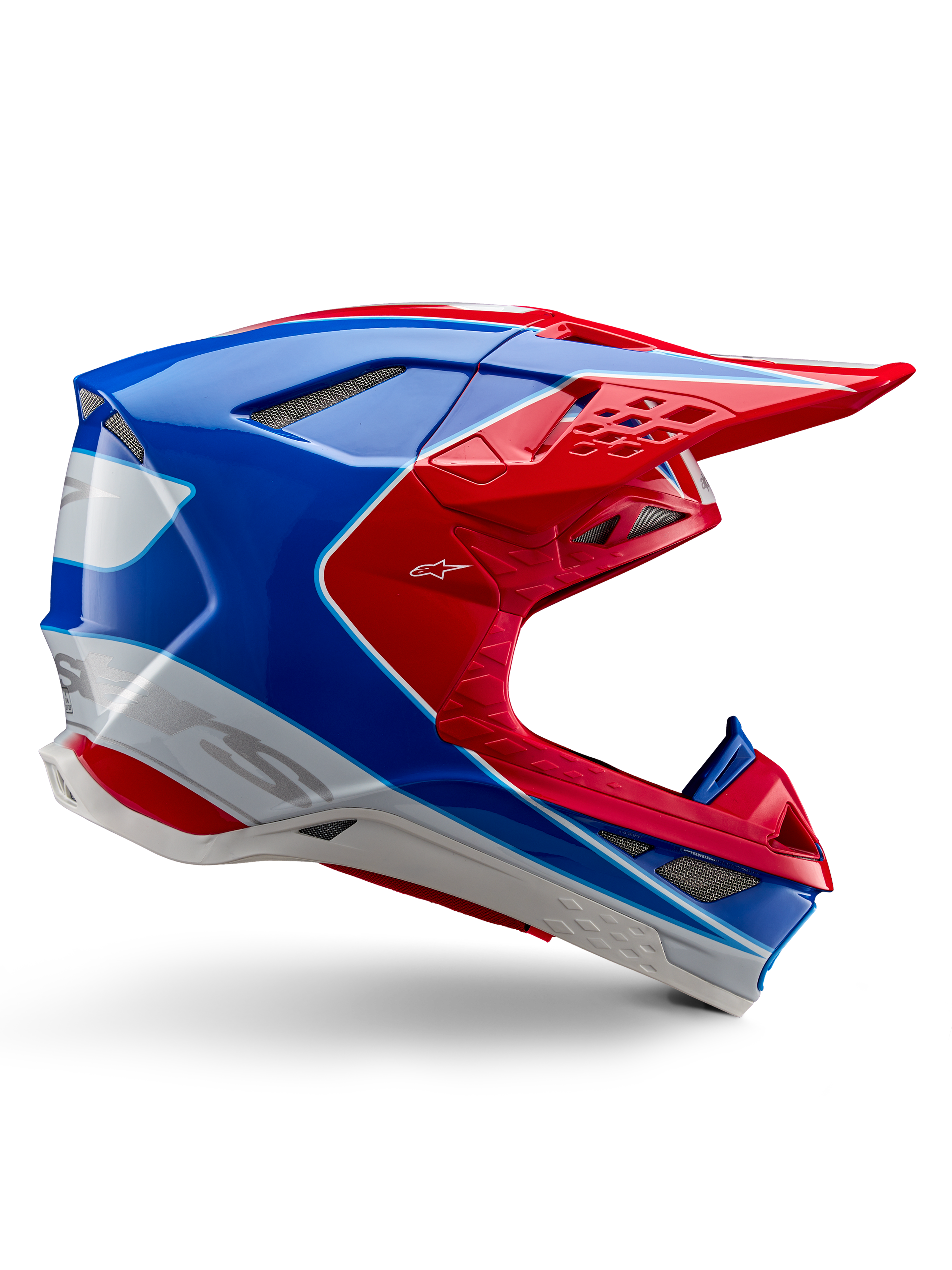 Alpinestars Supertech M10 Aeon Helmet, kask motocrossowy, jaskrawoczerwony, niebieski i biały, błyszczące wykończenie, aerodynamiczny profil boczny z licznymi otworami wentylacyjnymi z siatką, kanciaste kontury i daszek