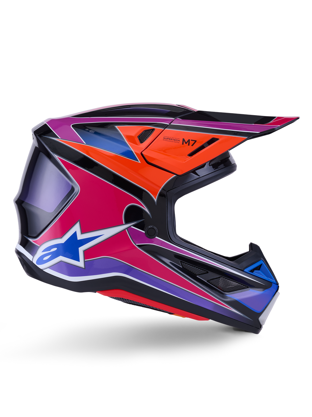 Kask Alpinestars S-M7 Fuse, kask motocrossowy, niebieski, fioletowy i różowy błyszczący, widok z profilu z żywą grafiką wyścigową, aerodynamiczna konstrukcja skorupy z otworami wentylacyjnymi i logo gwiazdy Alpinestars