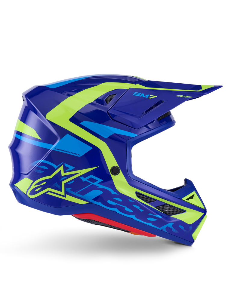 Alpinestars S-M7 Deed Helmet ECE 22.06, kask motocrossowy, niebiesko-żółty połysk (Blue Yellow Fluo Glossy), widok z boku, aerodynamiczna skorupa z wyraźnym logo Alpinestars, jaskrawożółte i jasnoniebieskie akcenty graficzne, liczne otwory wentylacyjne, zintegrowany daszek do wyścigów off-road