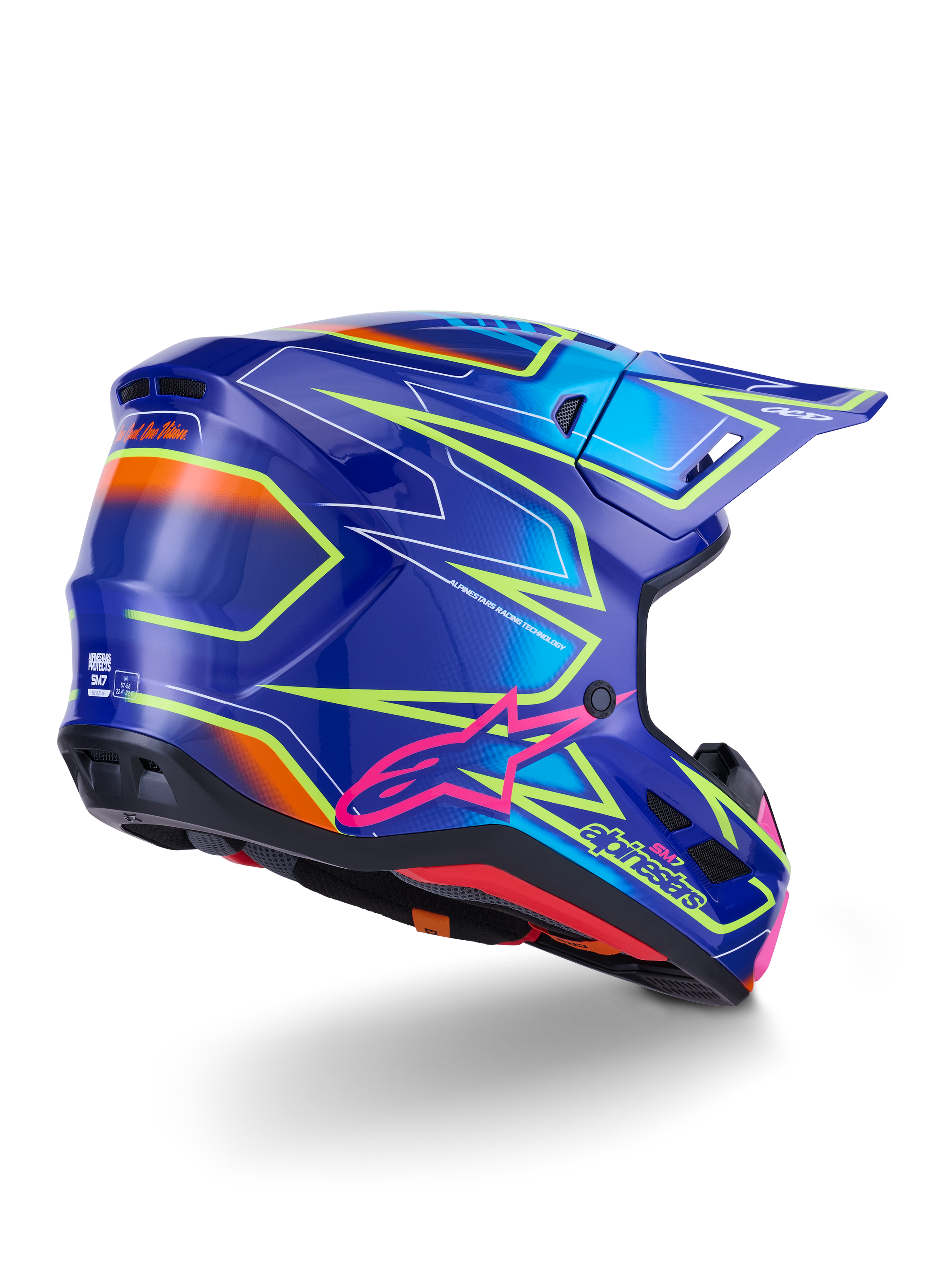 Kask Alpinestars S-M7 Cast, kask motocrossowy, błyszczący niebieski, różowy i żółty fluo, widok z tyłu pod kątem trzech czwartych ukazujący aerodynamiczną skorupę z wyrazistymi kanciastymi grafikami, różowe logo Astar i zintegrowane otwory wentylacyjne do wyścigów off-road
