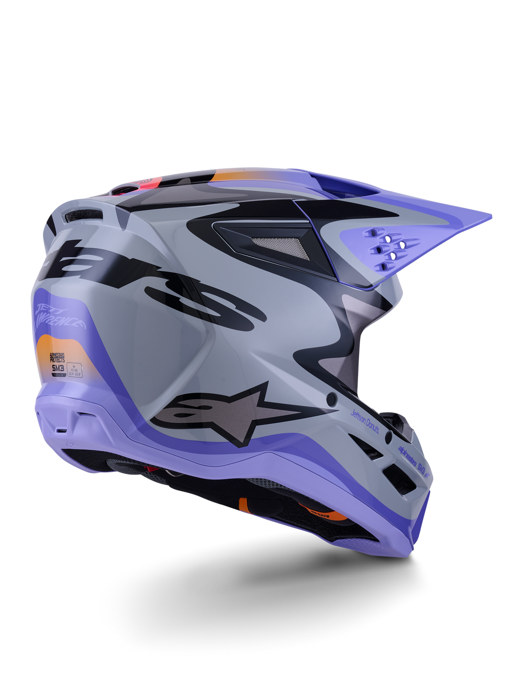 Alpinestars S-M3 Jettson Helmet ECE 22.06, kask motocrossowy, szary, fioletowy i czarny z połyskiem, widok z tyłu pod kątem trzech czwartych ukazujący aerodynamiczną termo-wtryskiwaną skorupę z otworami wentylacyjnymi i wyrazistym projektem graficznym