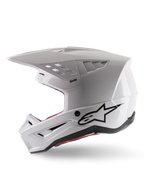 Alpinestars S-M5 Solid Helmet ECE 22.06, kask motocrossowy, biały połysk, widok z profilu bocznego z kanciastą konstrukcją skorupy, czarne logo Alpinestars z boku, liczne otwory wentylacyjne i zintegrowany daszek do wyścigów off-road.