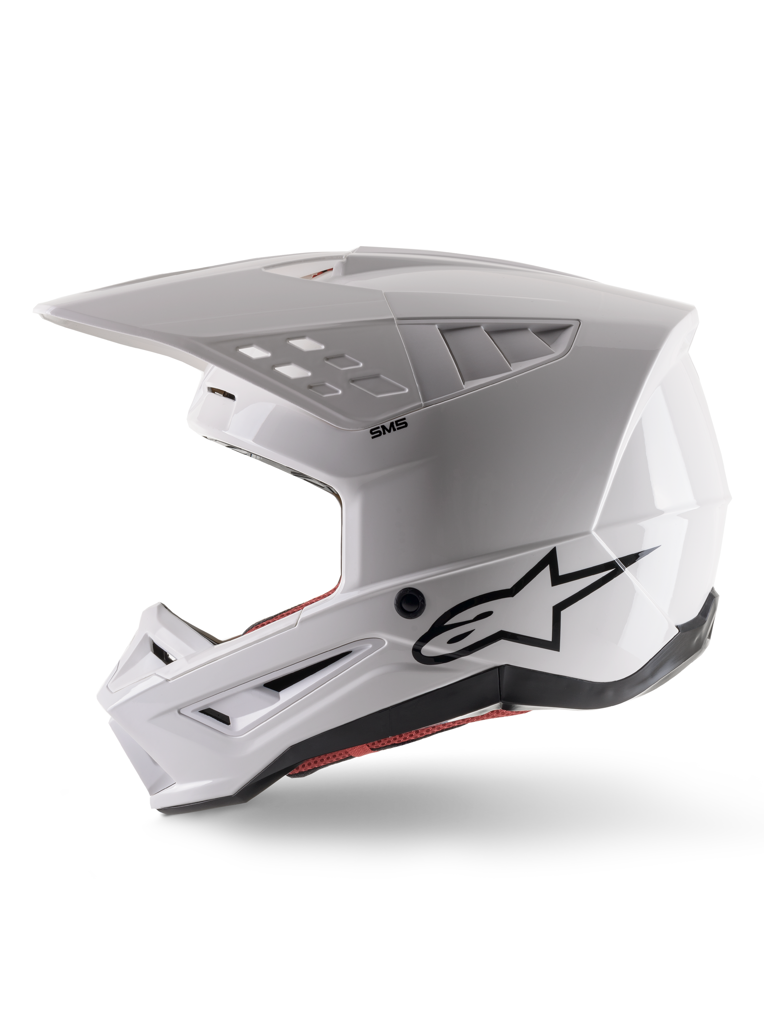 Alpinestars S-M5 Solid Helmet ECE 22.06, kask motocrossowy, biały połysk, widok z profilu bocznego z kanciastą konstrukcją skorupy, czarne logo Alpinestars z boku, liczne otwory wentylacyjne i zintegrowany daszek do wyścigów off-road.