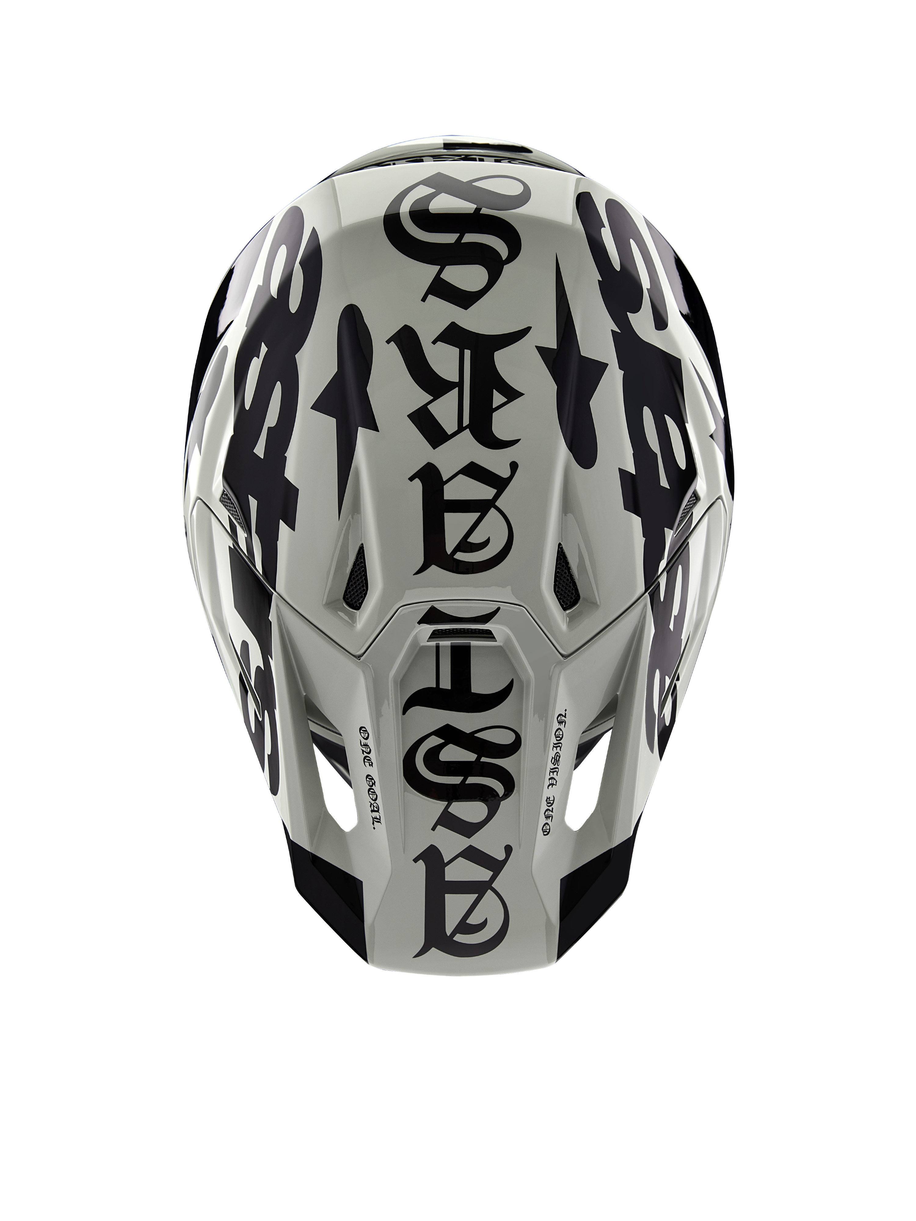 Kask Alpinestars Limited Edition S-M7 Wolf Dust, widok z góry, połyskujące wykończenie w kolorach Dune i czarnym, z wyrazistą typografią w stylu gotyckim na górze skorupy i detalami One Goal One Vision, profesjonalna ochrona głowy do wyścigów motocrossowych